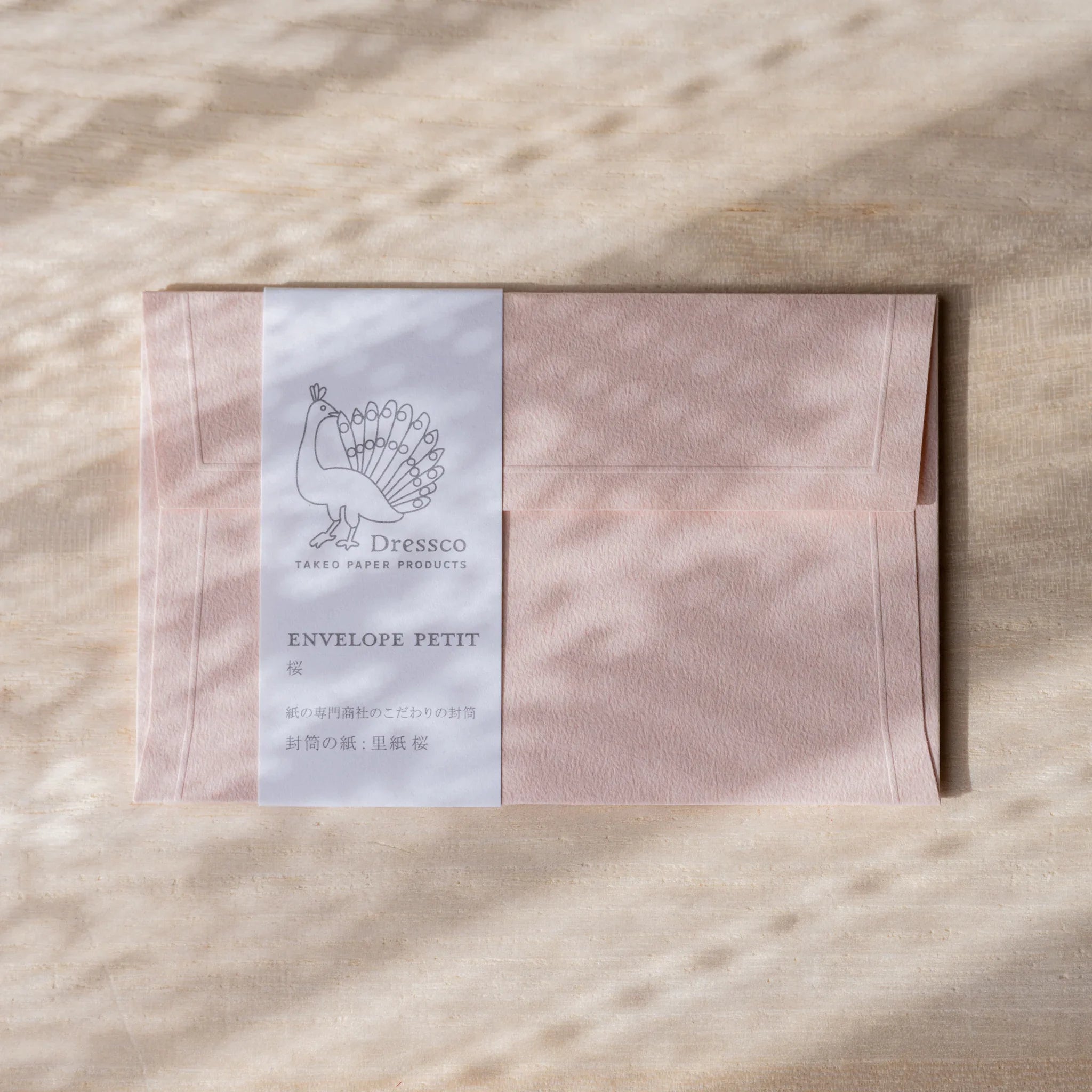 Dressco embossed small envelope in sage green, flat lay showing subtle texture