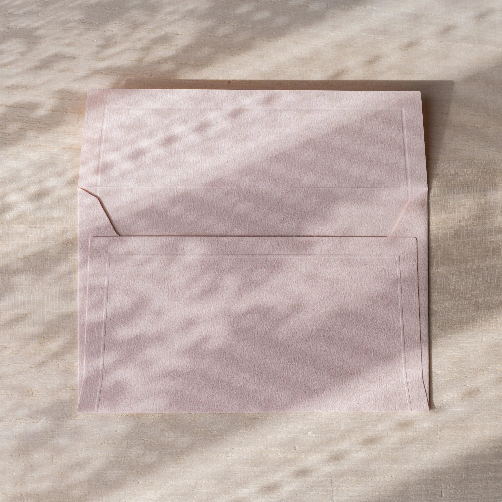 Dressco envelope collection featuring soft toned, close-up detail highlighting q