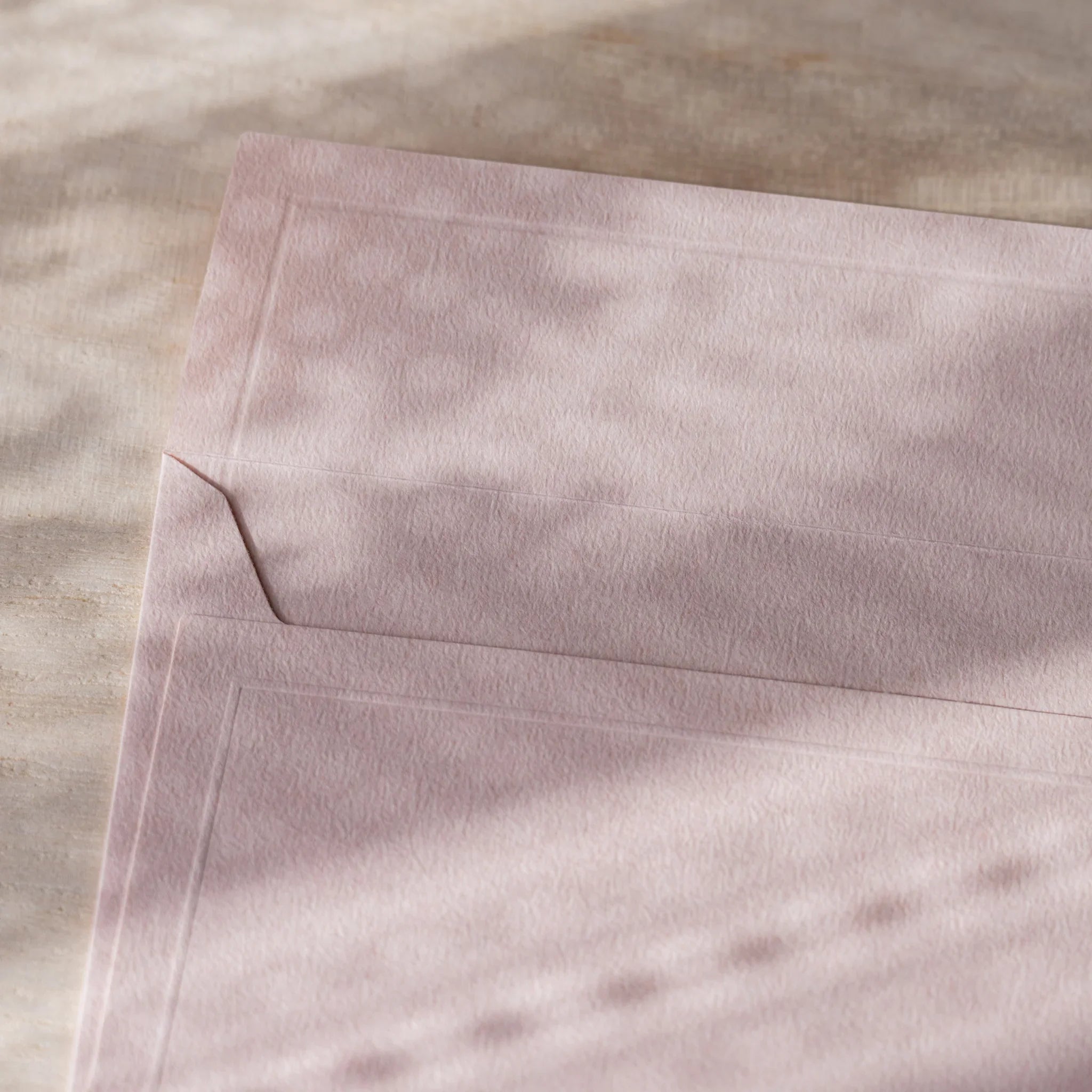 Dressco embossed small envelope in white, fanned arrangement subtle texture