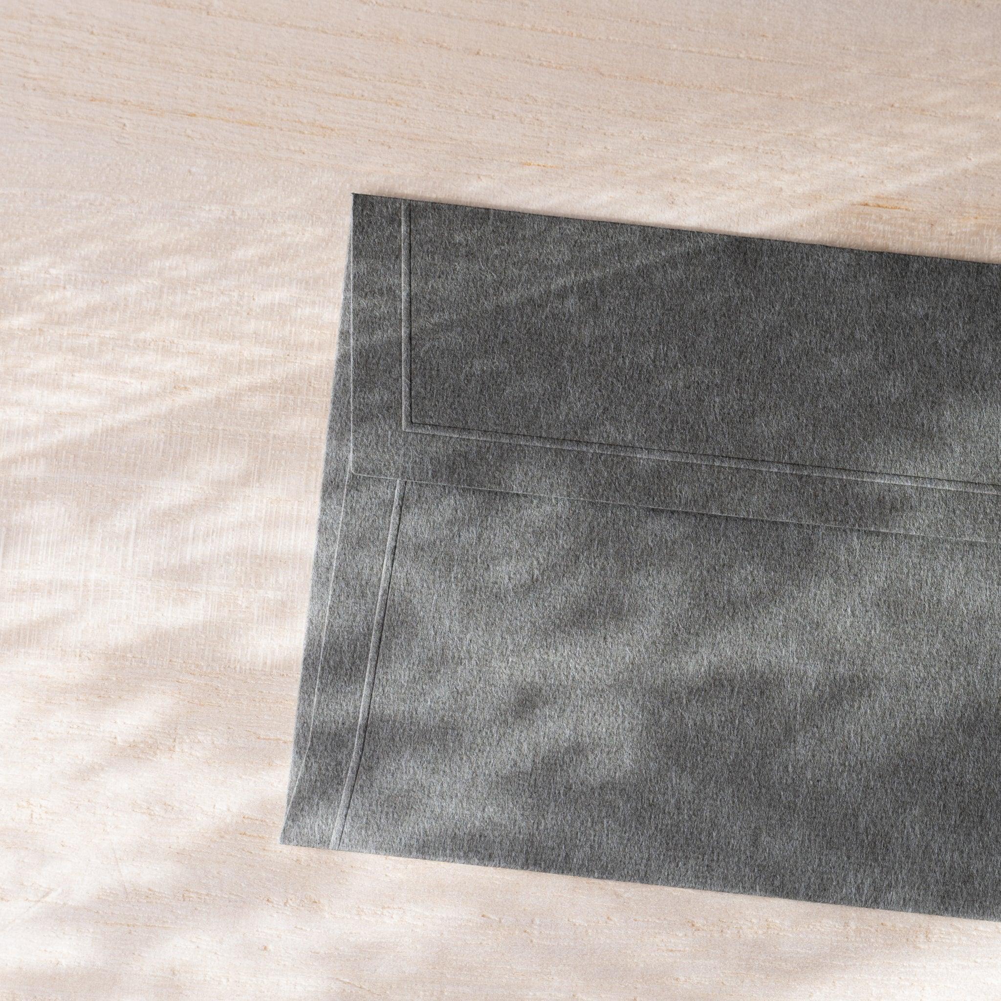 Dressco small embossed envelope, white tone, flat lay displaying design pattern