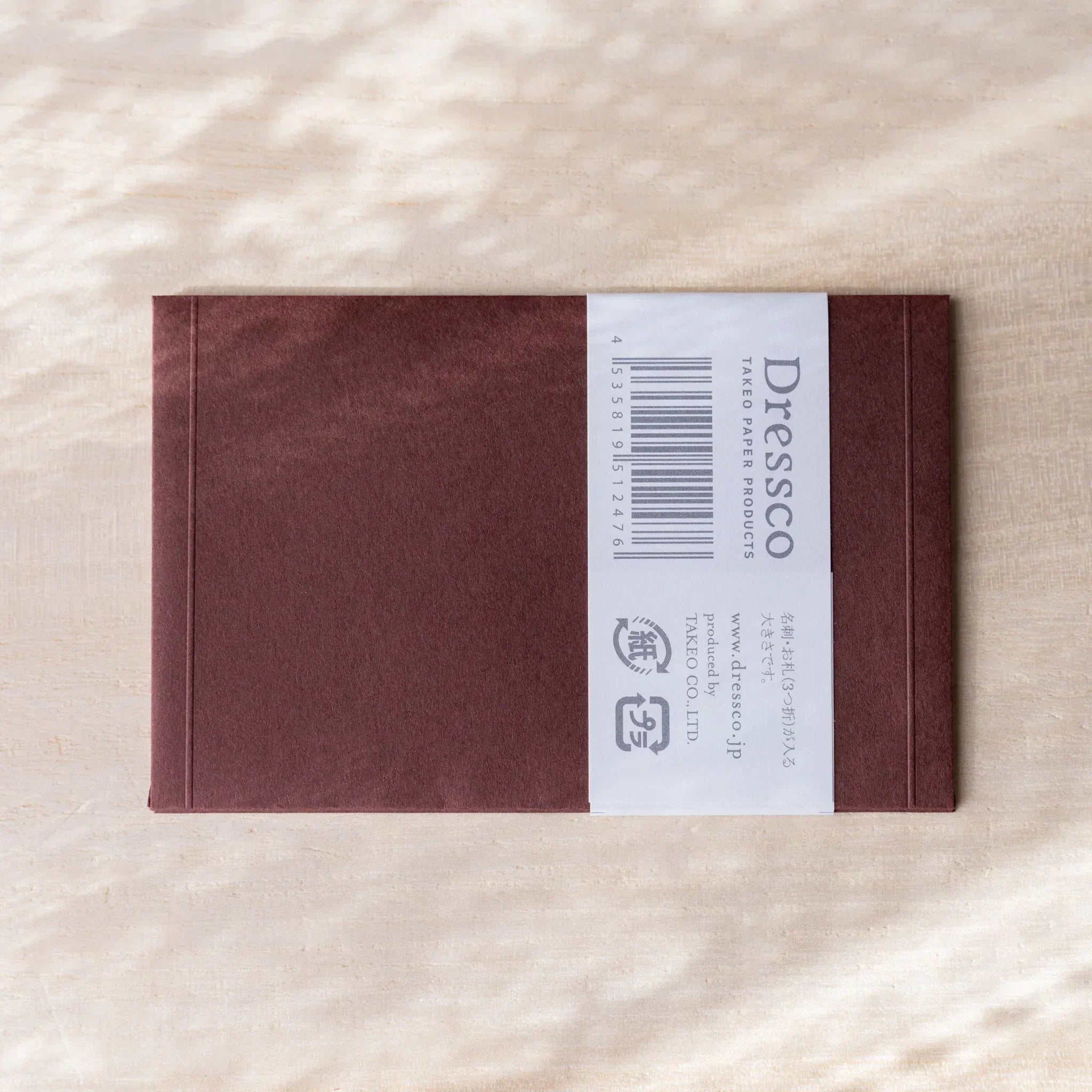 Dressco embossed envelope, pastel shade, product photo highlighting seal detail