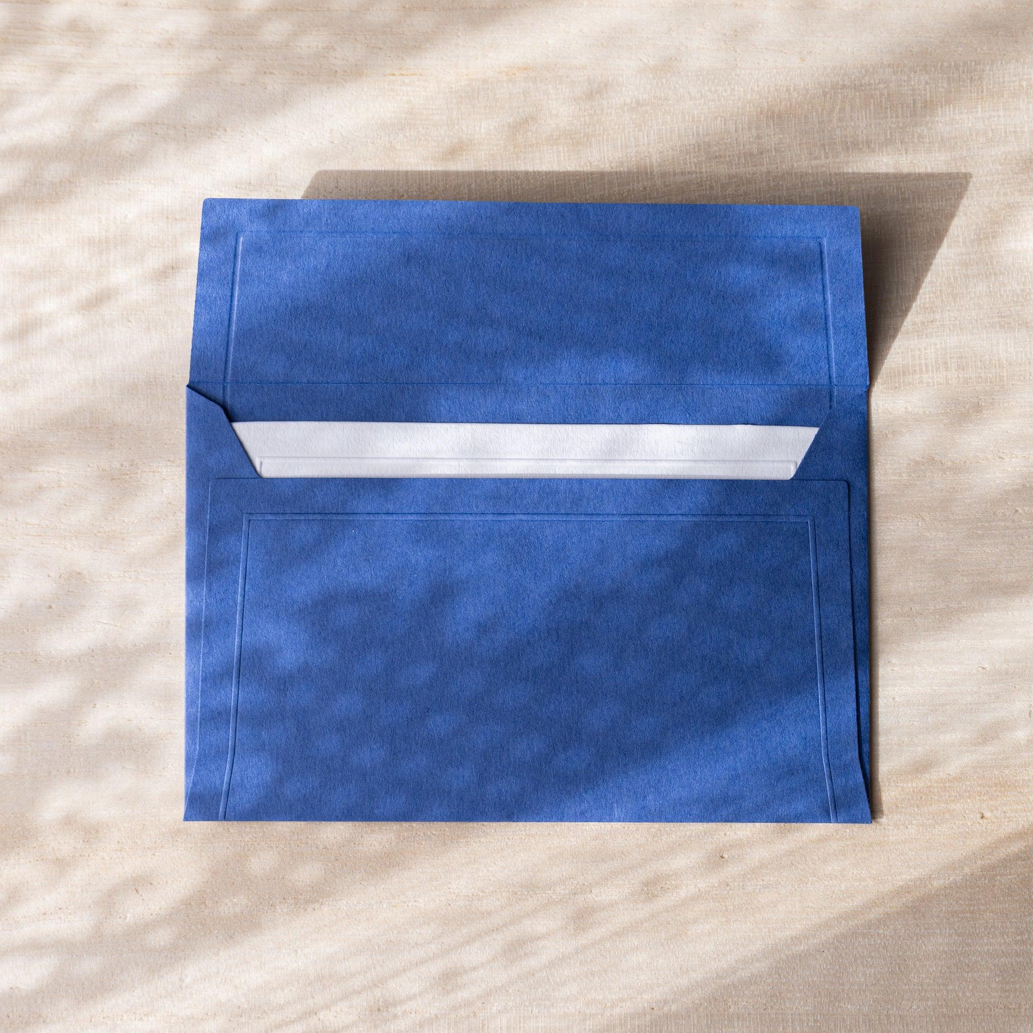 Dressco envelope, white shade, flat lay displaying embossed surface composition
