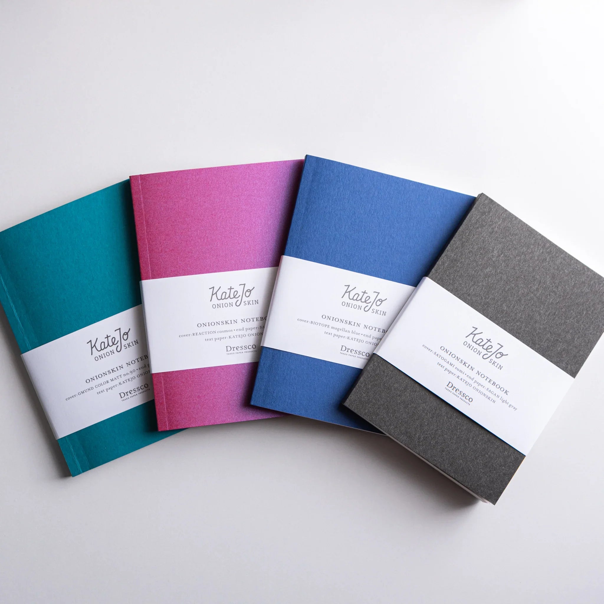 Four Dressco Onion Skin Japanese Notebooks in teal, pink, blue, and black, arranged diagonally.
