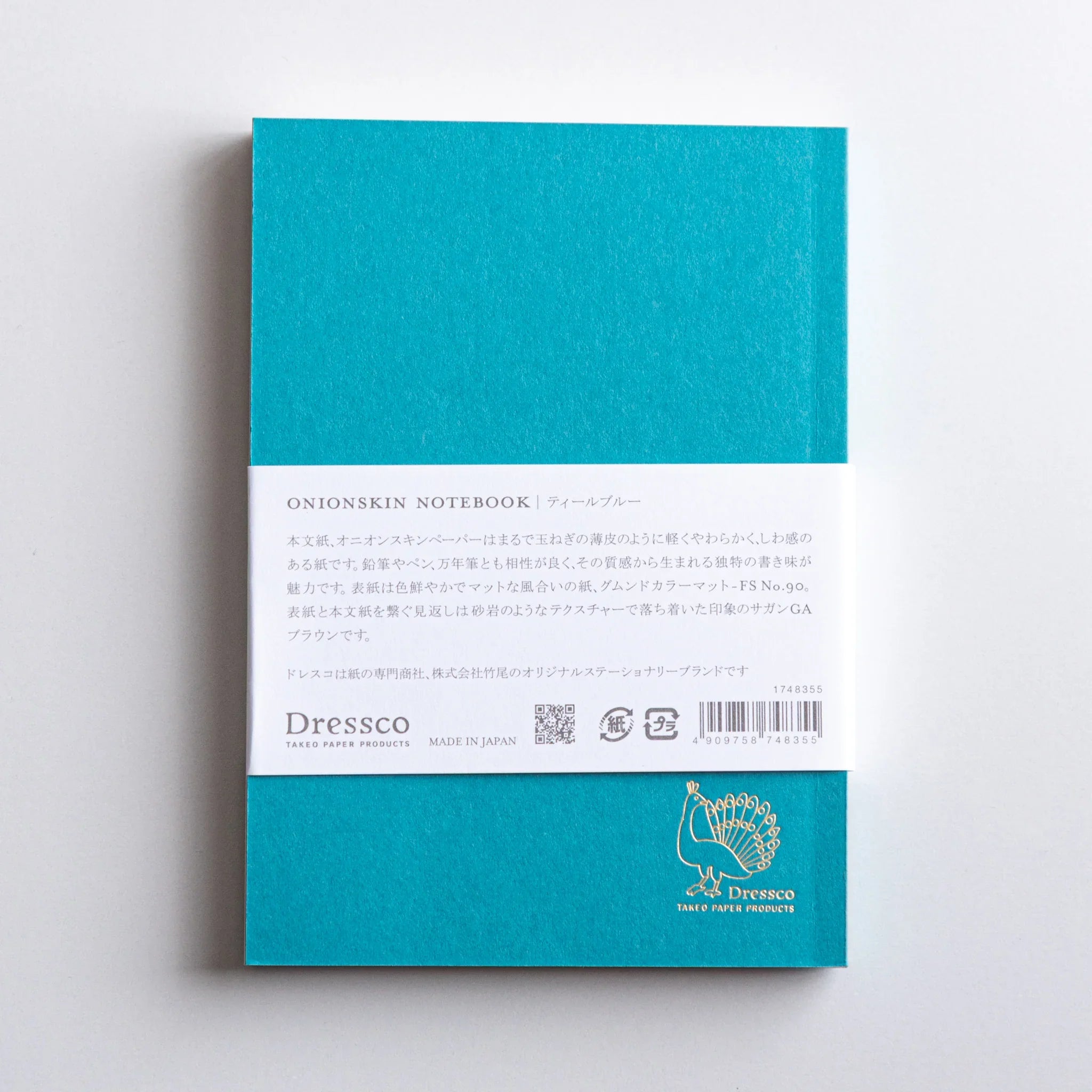 Back cover of Dressco Teal Blue Onion Skin Japanese Notebook A6 with gold peacock Dressco logo.