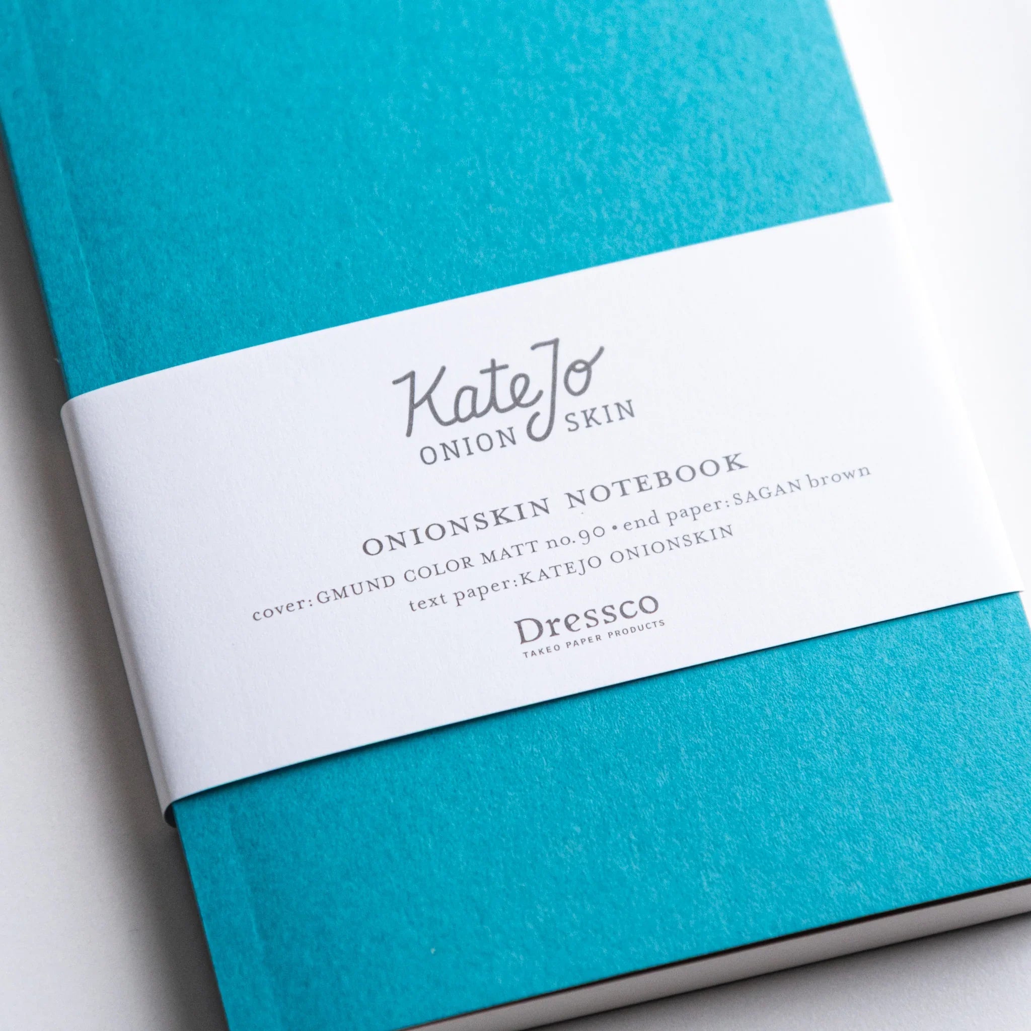 Close-up of Dressco Teal Blue Onion Skin Japanese Notebook A6 showing texture and printed label.