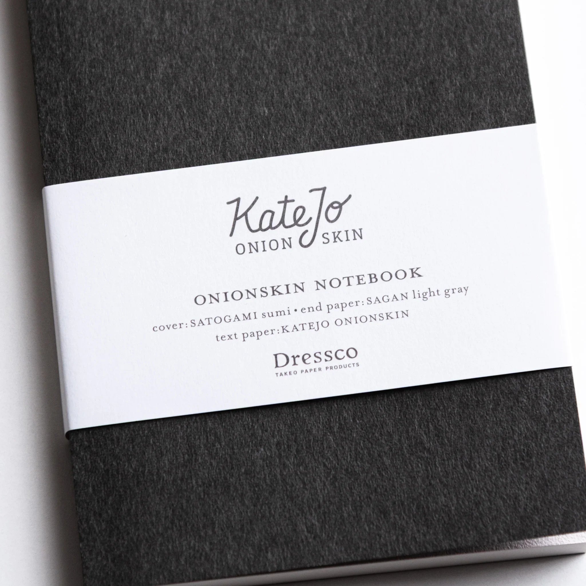Close-up of Dressco Black Onion Skin Japanese Notebook A6 with soft black texture and white label.