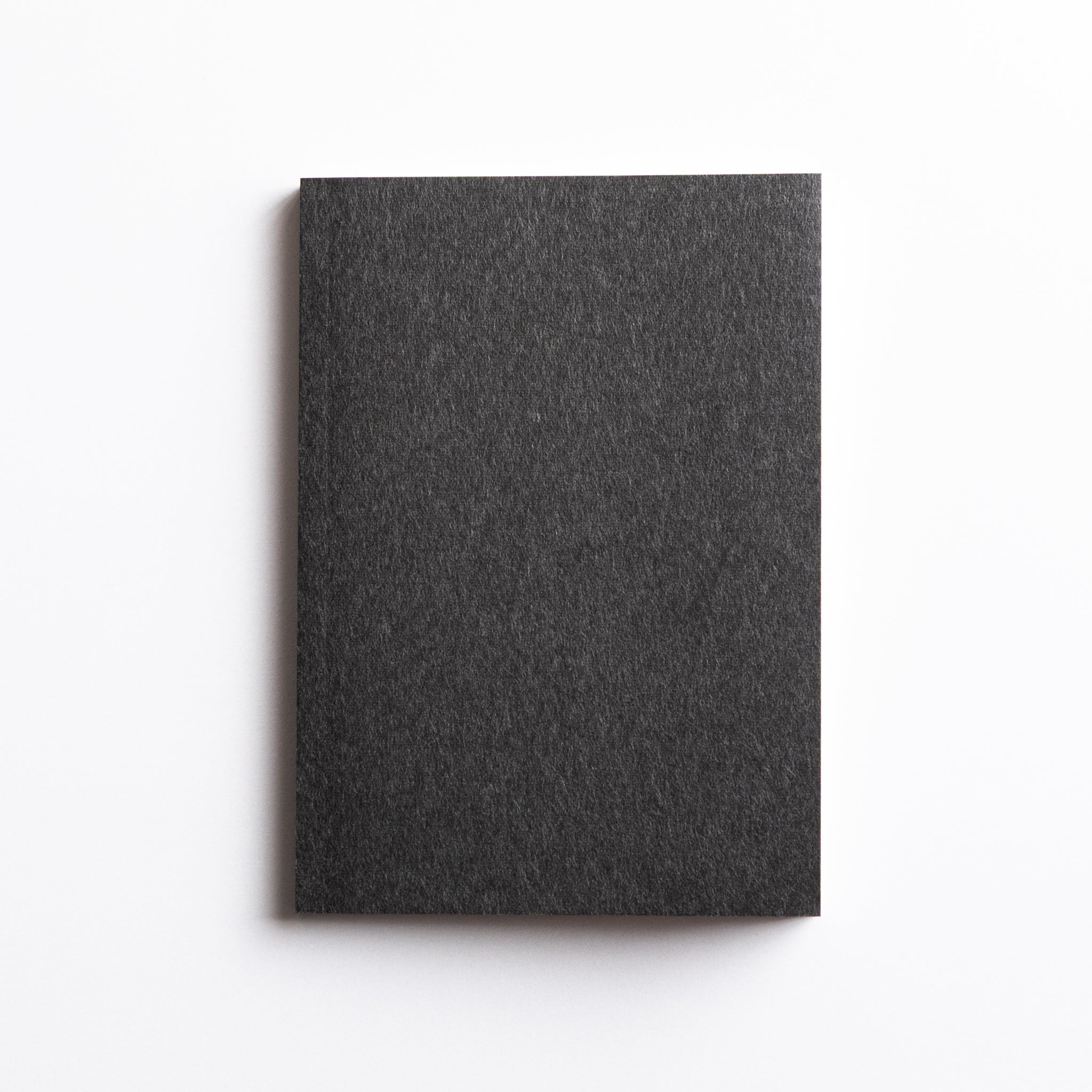 Top-down flat lay of Dressco Onion Skin Paper A6 notebook fourth variant showing cover design and precise format
