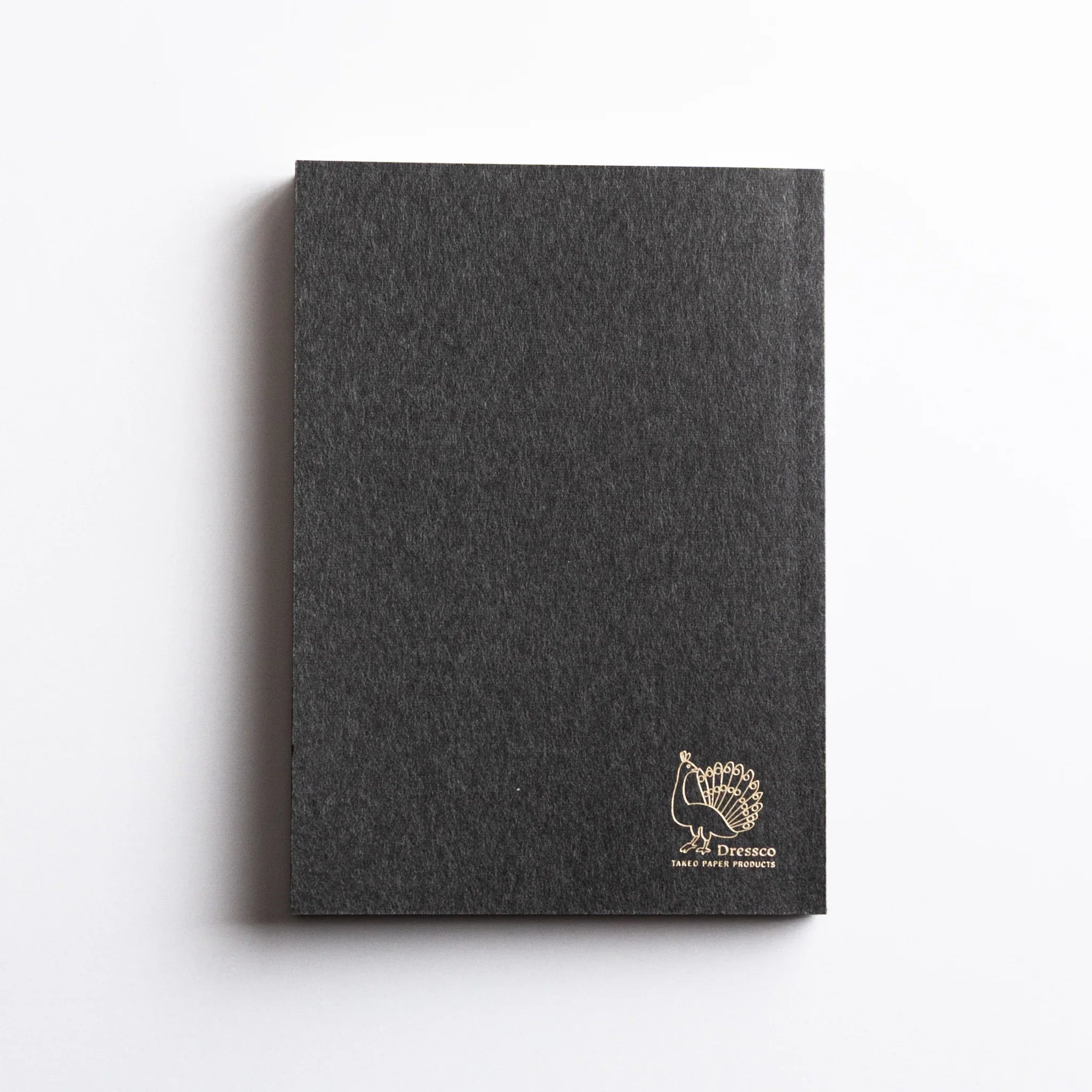 Dressco Black Onion Skin Japanese Notebook A6 with gold peacock logo embossed on the back cover.