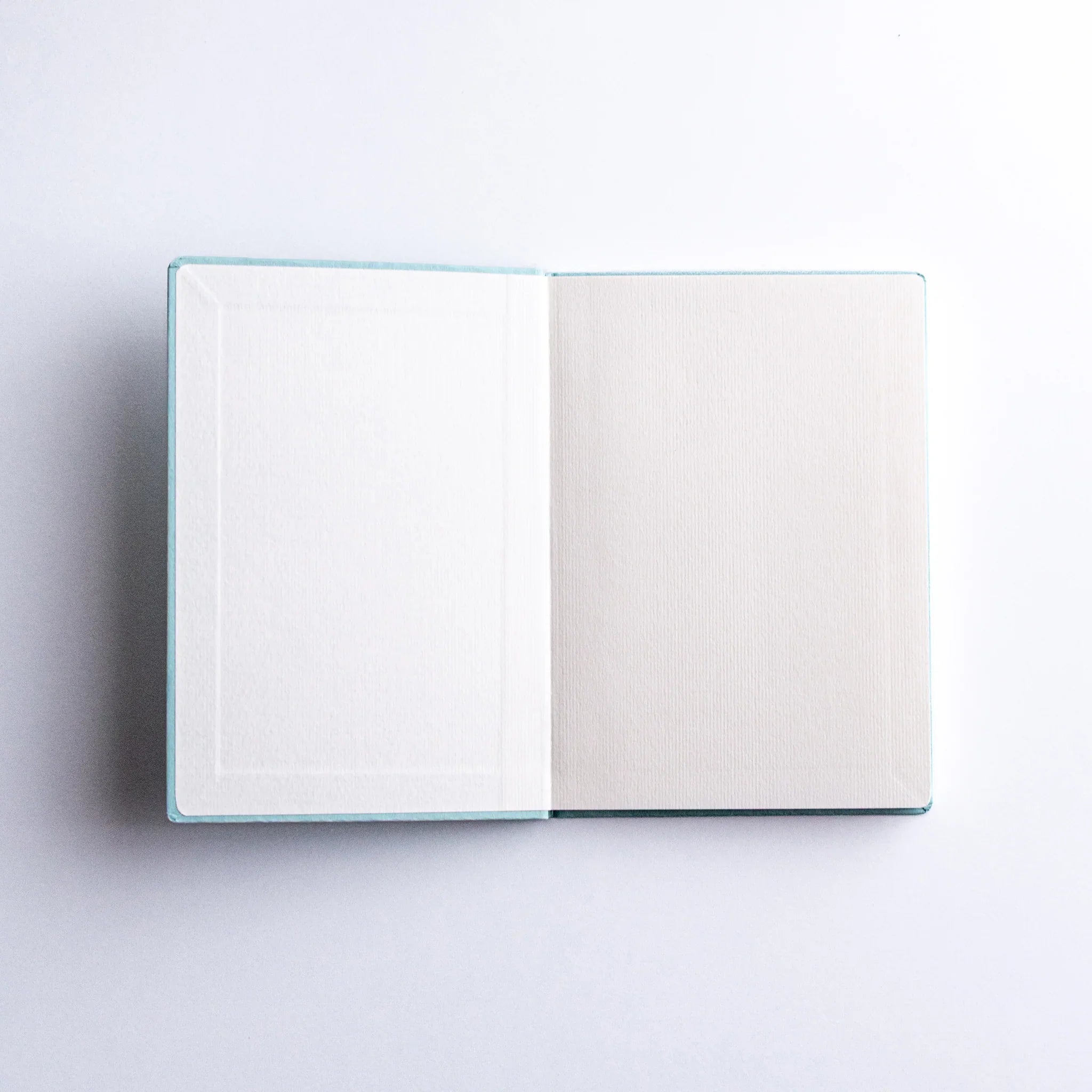 Dressco Spica Laid Bond Paper A6 Japanese notebook shown in a flat composition view with cover facing up