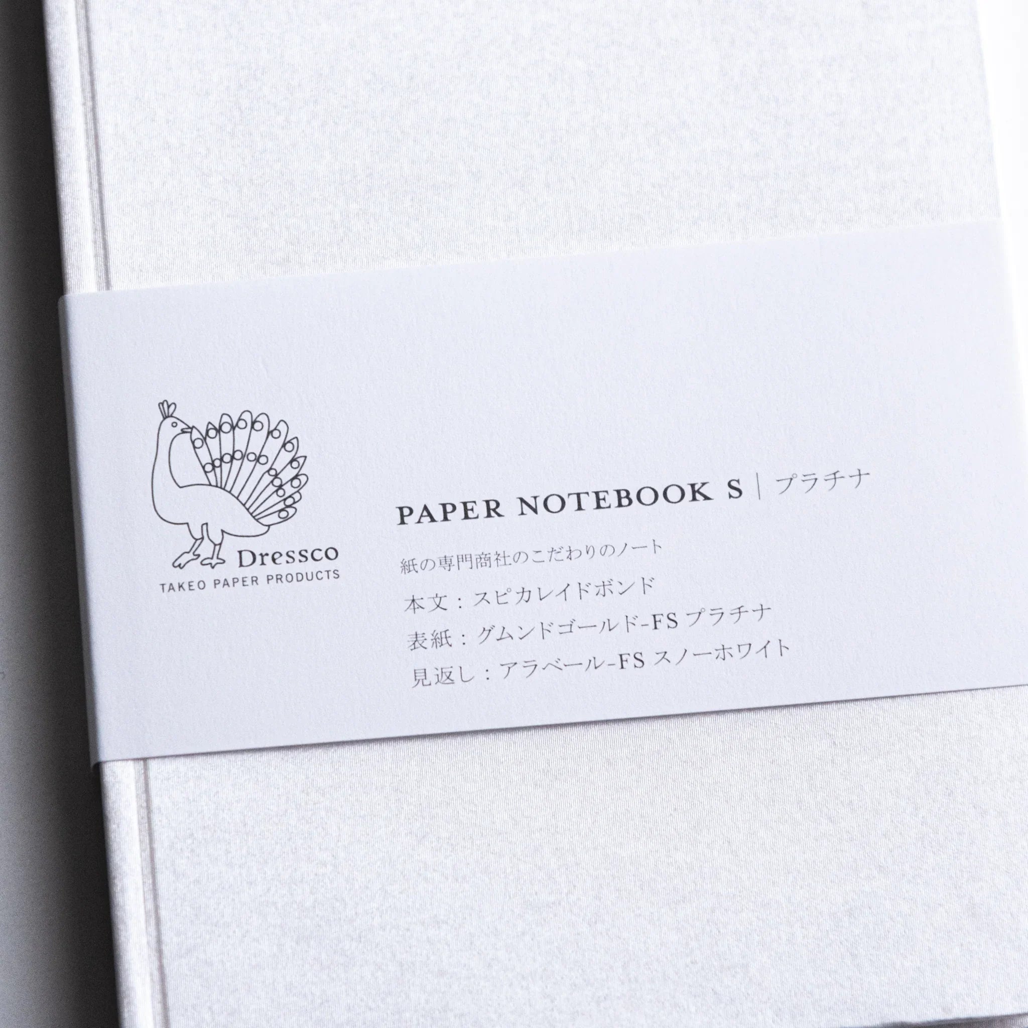 Top-down flat lay of Dressco Spica Laid Bond Paper A6 notebook showing full cover dimensions on a flat surface