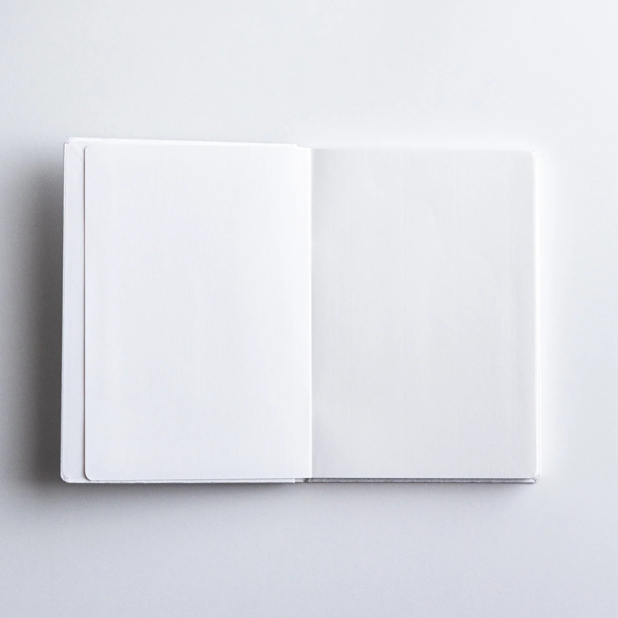 Dressco Spica Laid Bond Paper A6 notebook three-quarter angle view showing cover face and spine thickness together