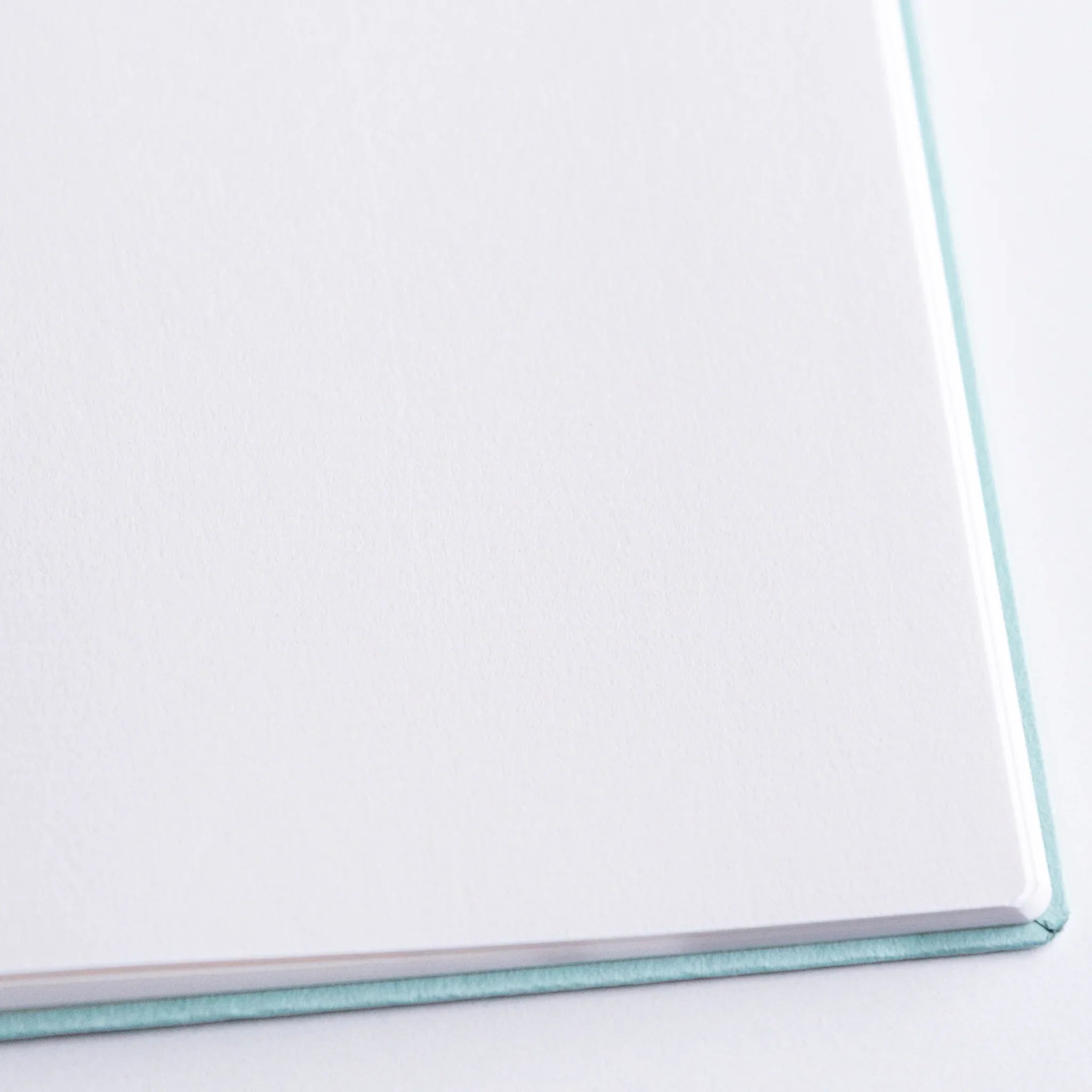 Close-up of edge and binding of Dressco Spica Laid Bond Japanese Notebook B6 showing craftsmanship.