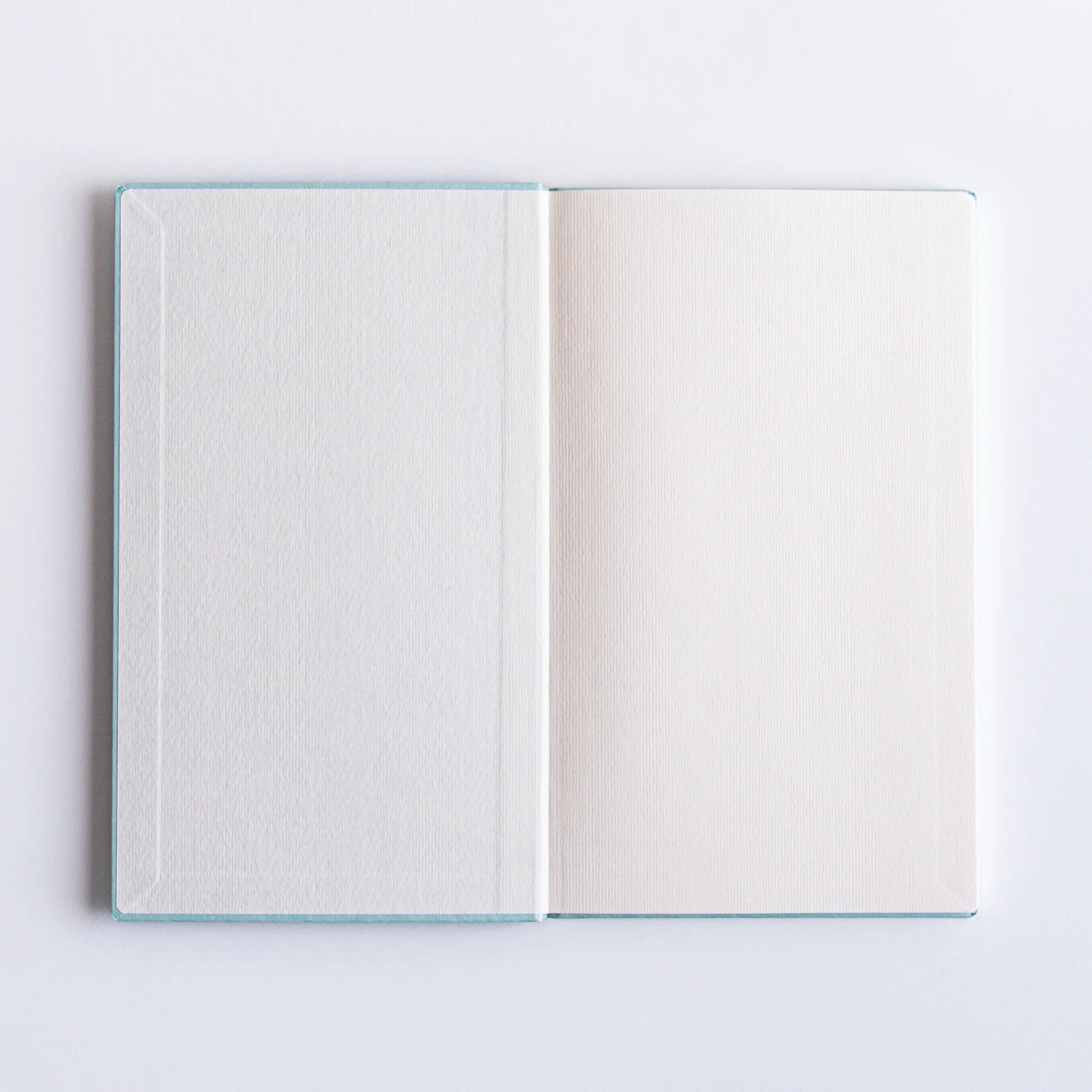 Overhead view of Dressco Spica Laid Bond Paper B6 notebook displaying cover design and B6 page format from above