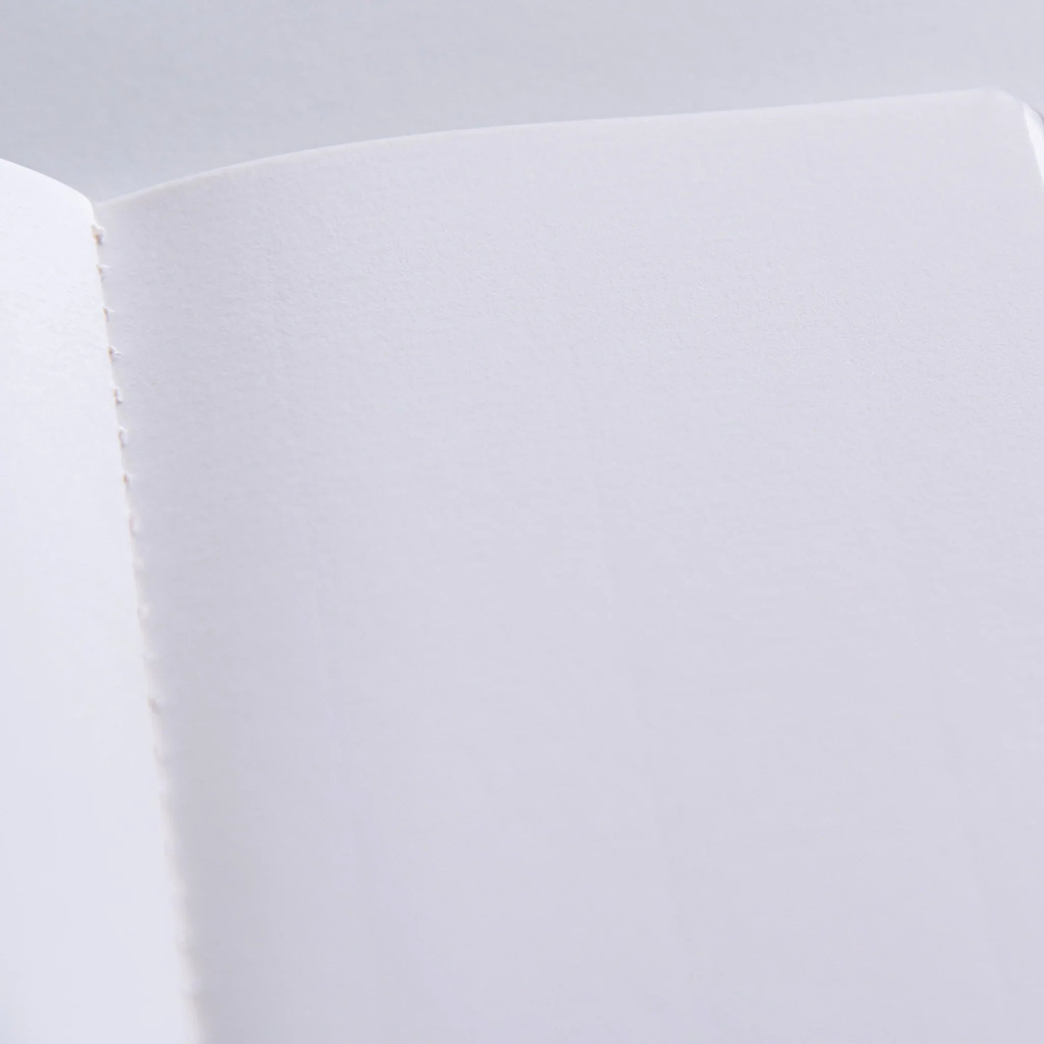 Dressco Spica Laid Bond Stitched A6 notebook side view showing full spine depth and the sewn binding construction