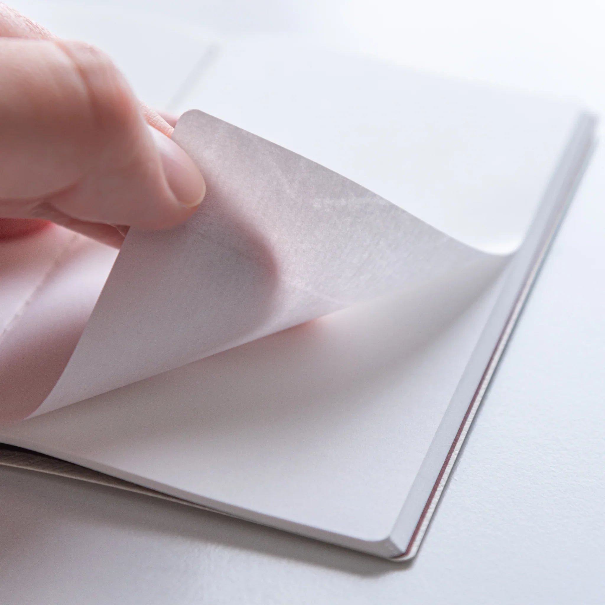 Dressco Spica Laid Bond Stitched A6 notebook opened flat showing interior ruled pages and laid bond paper surface