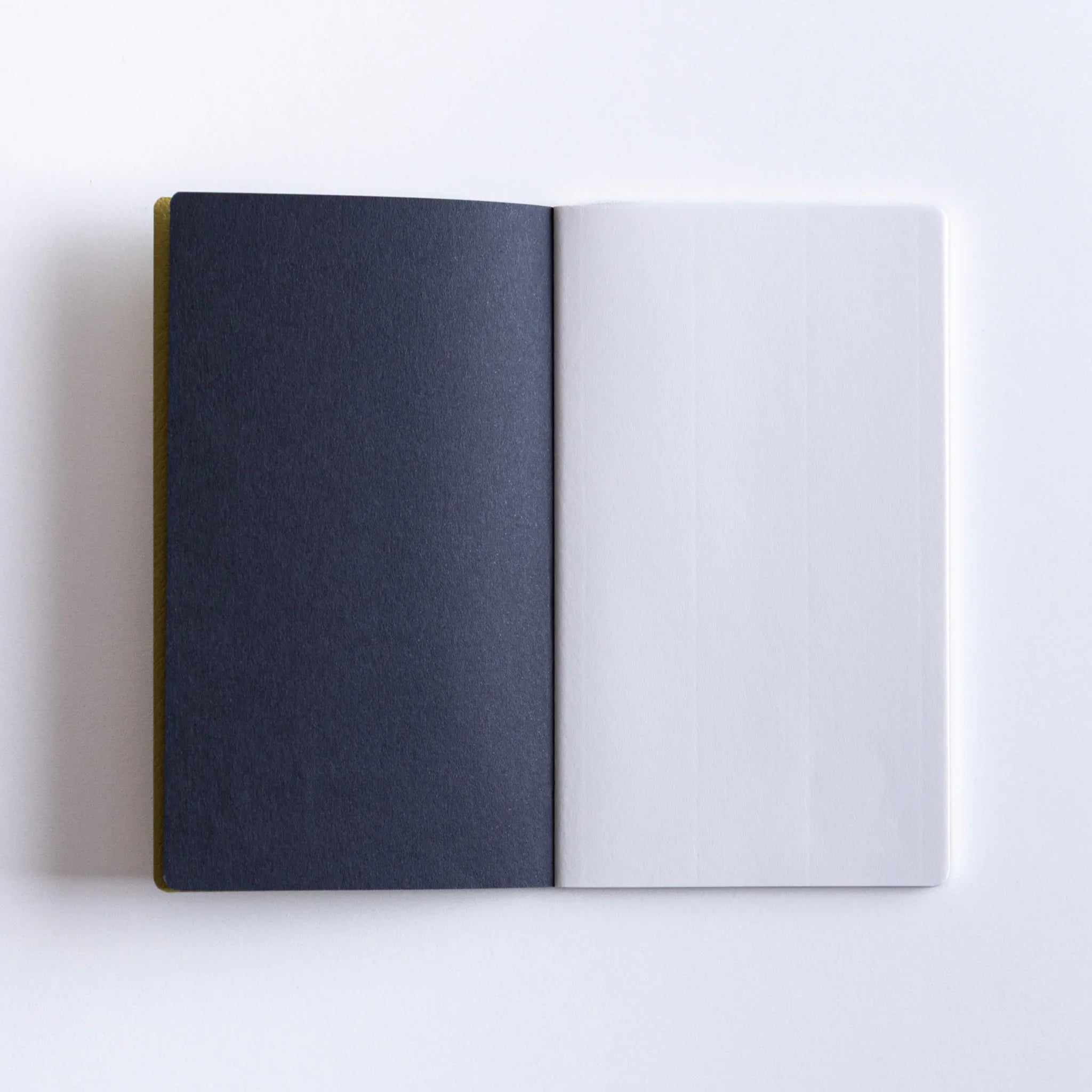 Dressco Spica Laid Bond Stitched A6 notebook at angle showing the cover surface and stitched binding on the spine
