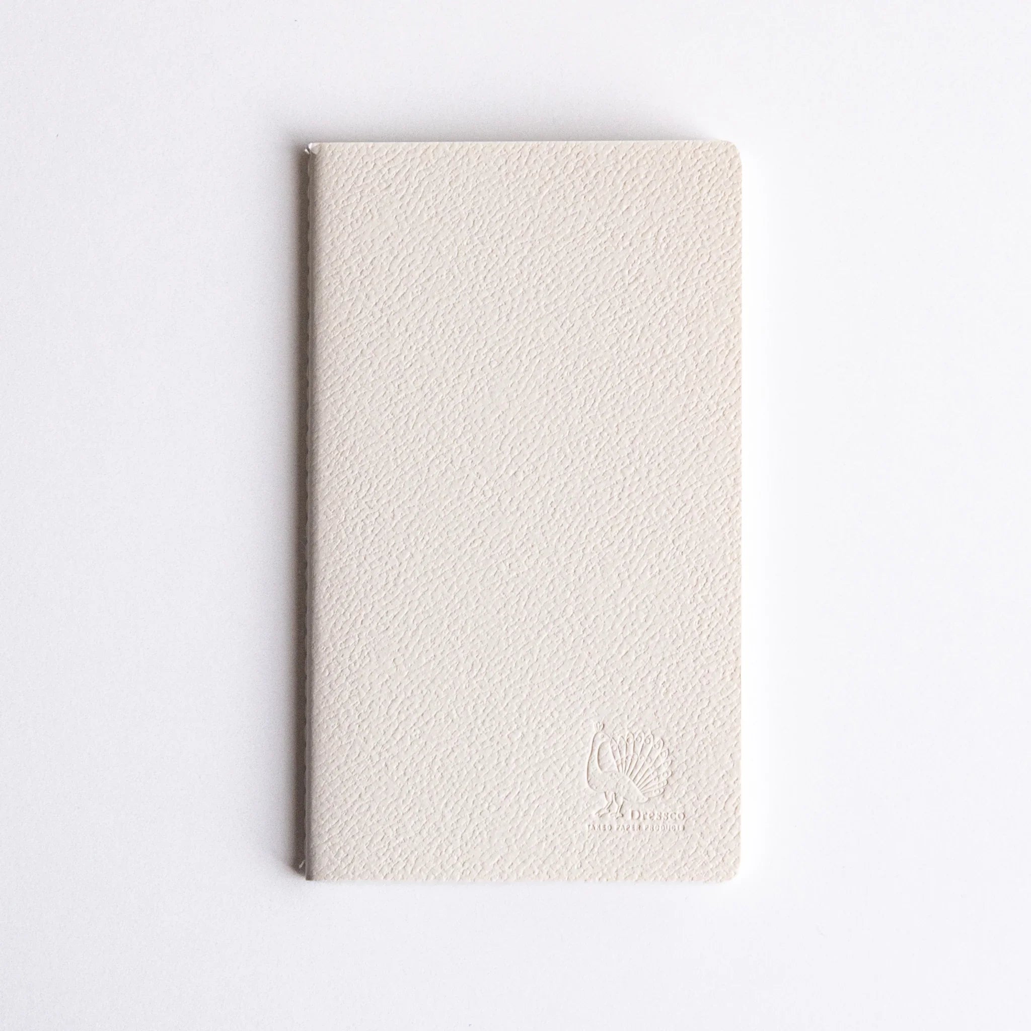 Minimalist Japanese notebook made with Spica Laid Bond Paper, featuring a textured white cover and stitched binding.