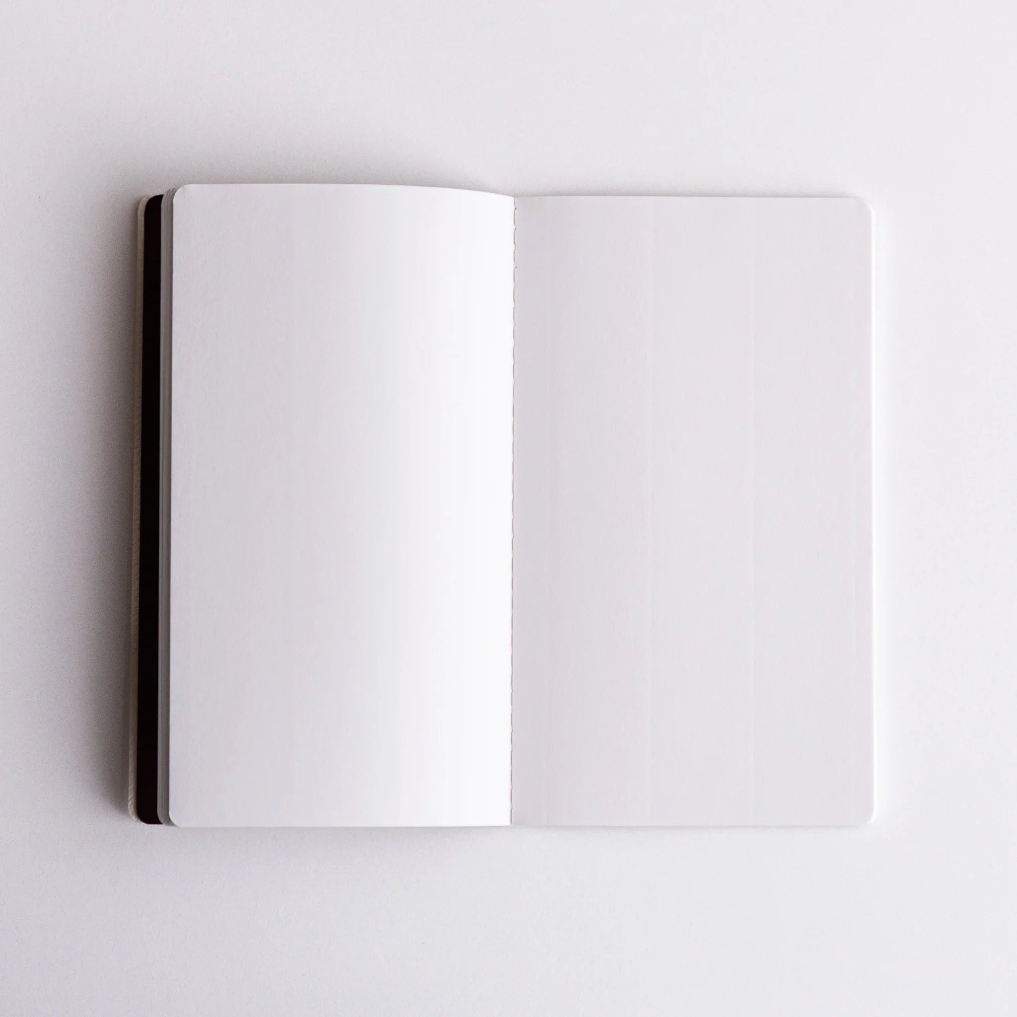Open Japanese notebook made with Spica Laid Bond Paper, showing blank white pages and stitched binding for a clean writing surface.