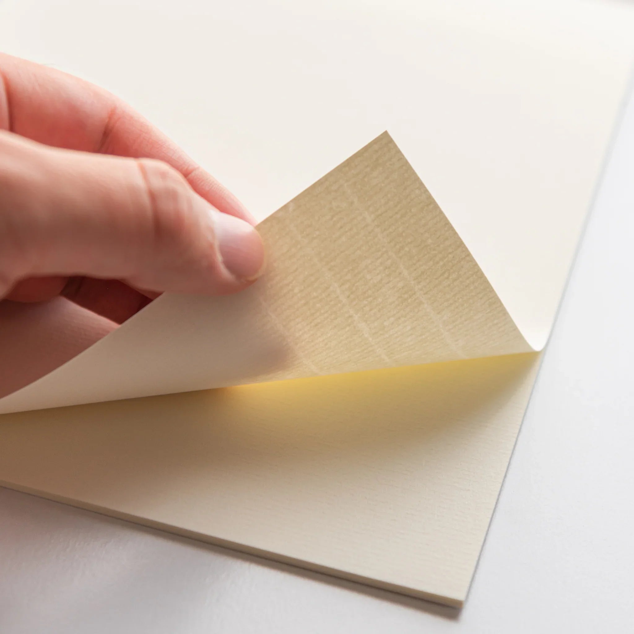 Japanese writing pad Strathmore Writing Laid N hand lifting cream laid sheet from pad showing texture