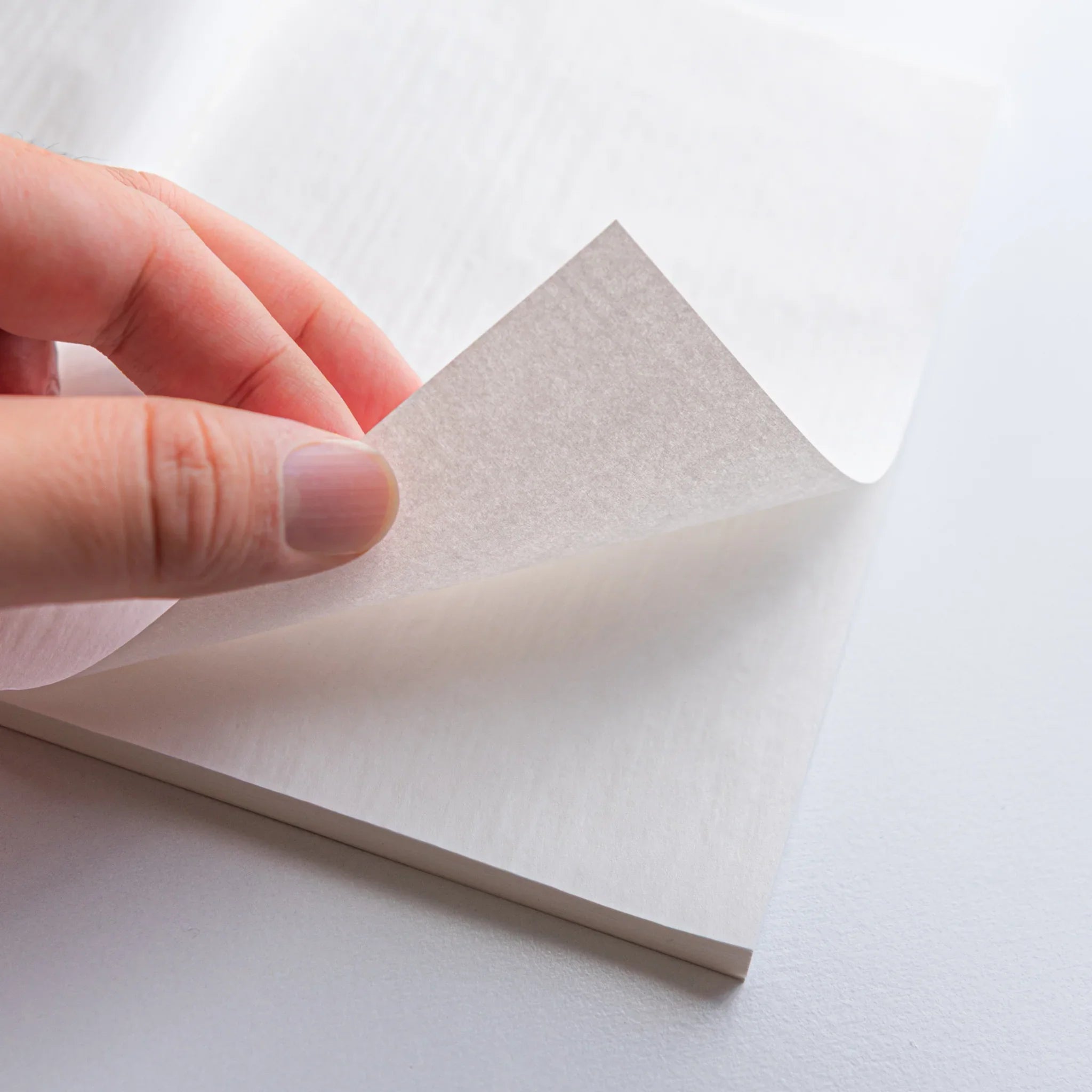 Angled perspective of KateJo B6 Onion Skin notebook showing cover and internal page structure in composition