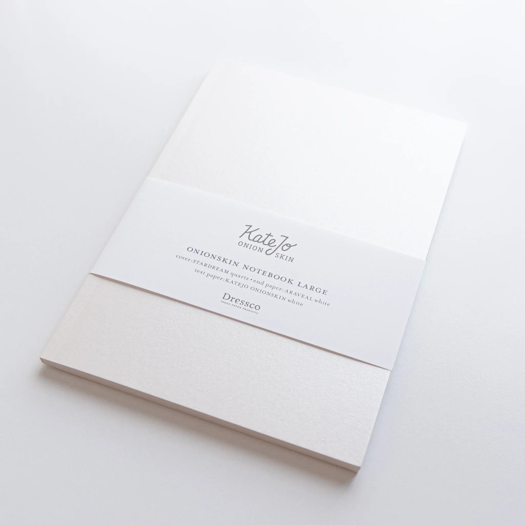 White B6 Onion Skin notebook closed view on light surface showing cover design and structure in composition