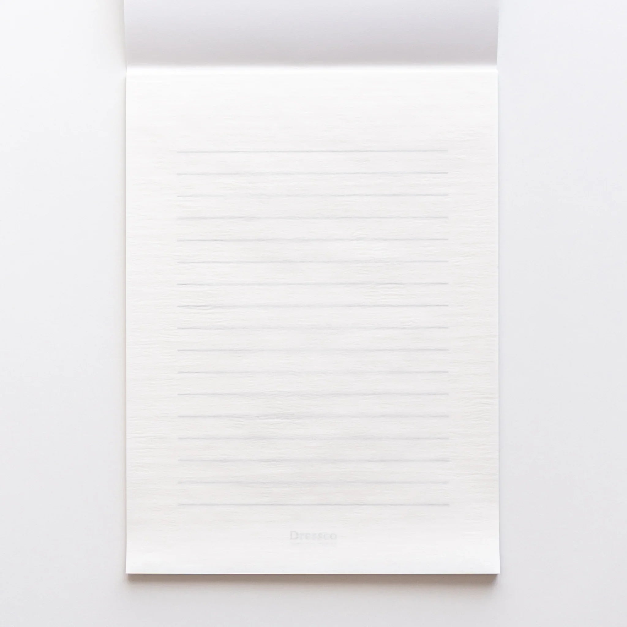 White Onion Skin writing pad opened flat showing thin translucent pages and paper structure in composition
