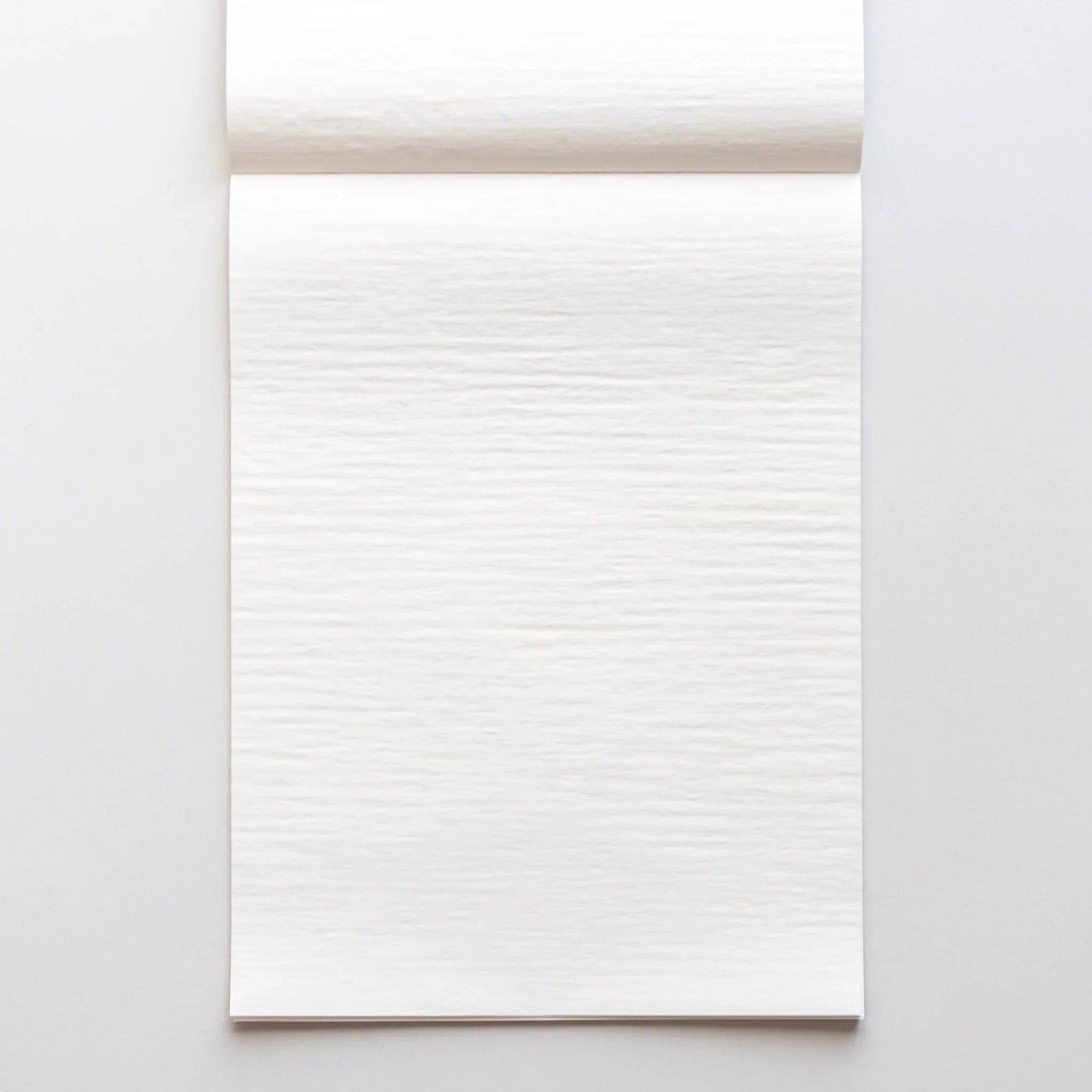 White writing pad in flat lay showing clean cover with information bands and overall text layout composition shown