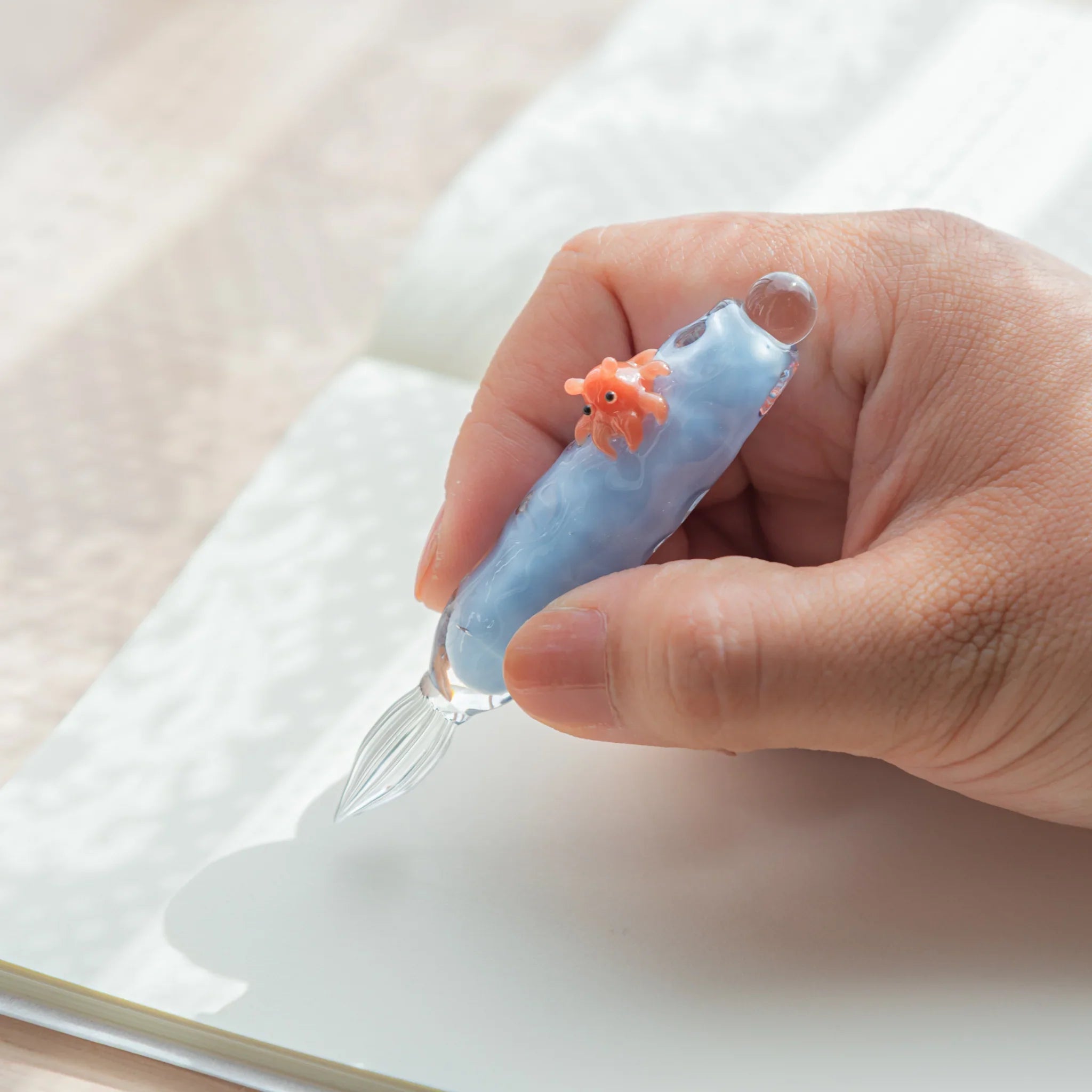 Whimsical dumbo octopus glass dip pen featuring distinctive ear-like fins and hand-blown glass barrel