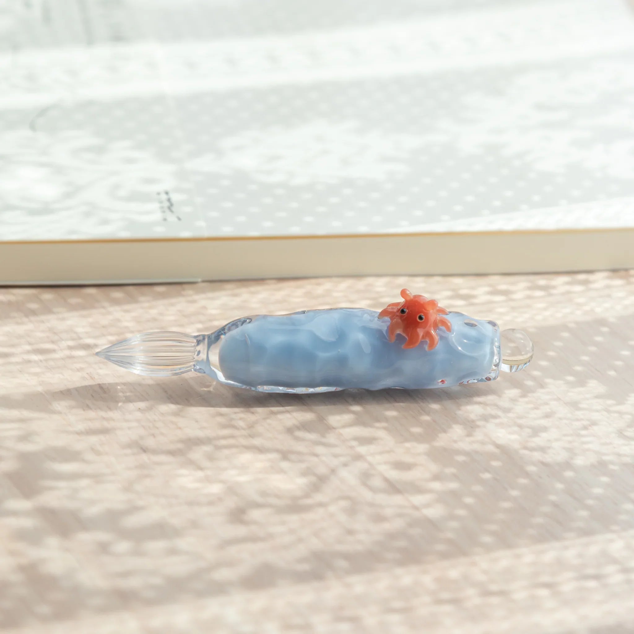 Glass dip pen with charming dumbo octopus design clutching colorful hand-poured glass ink container design