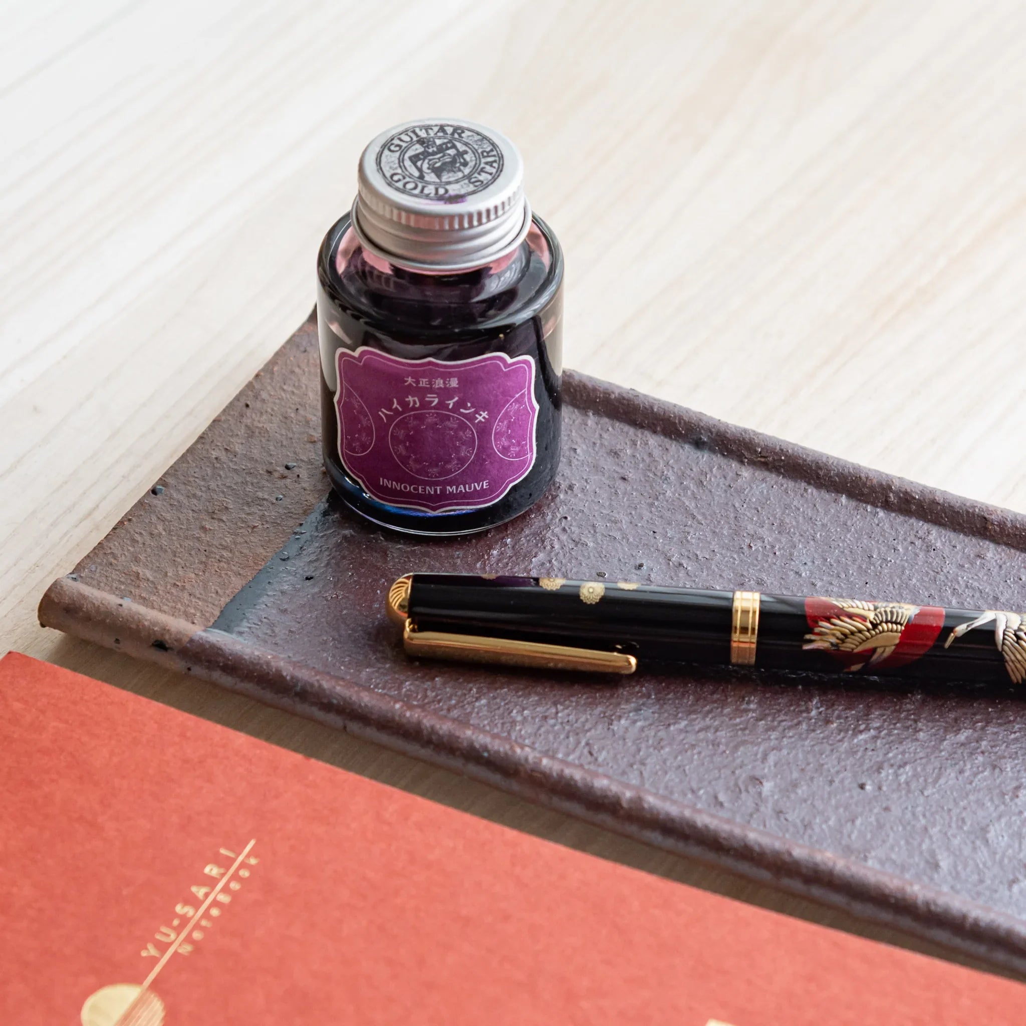 Japanese Pen Tray Desk Accessory, yakishime-clay ceramic tray with fountain pen and ink placed diagonally and notebook.