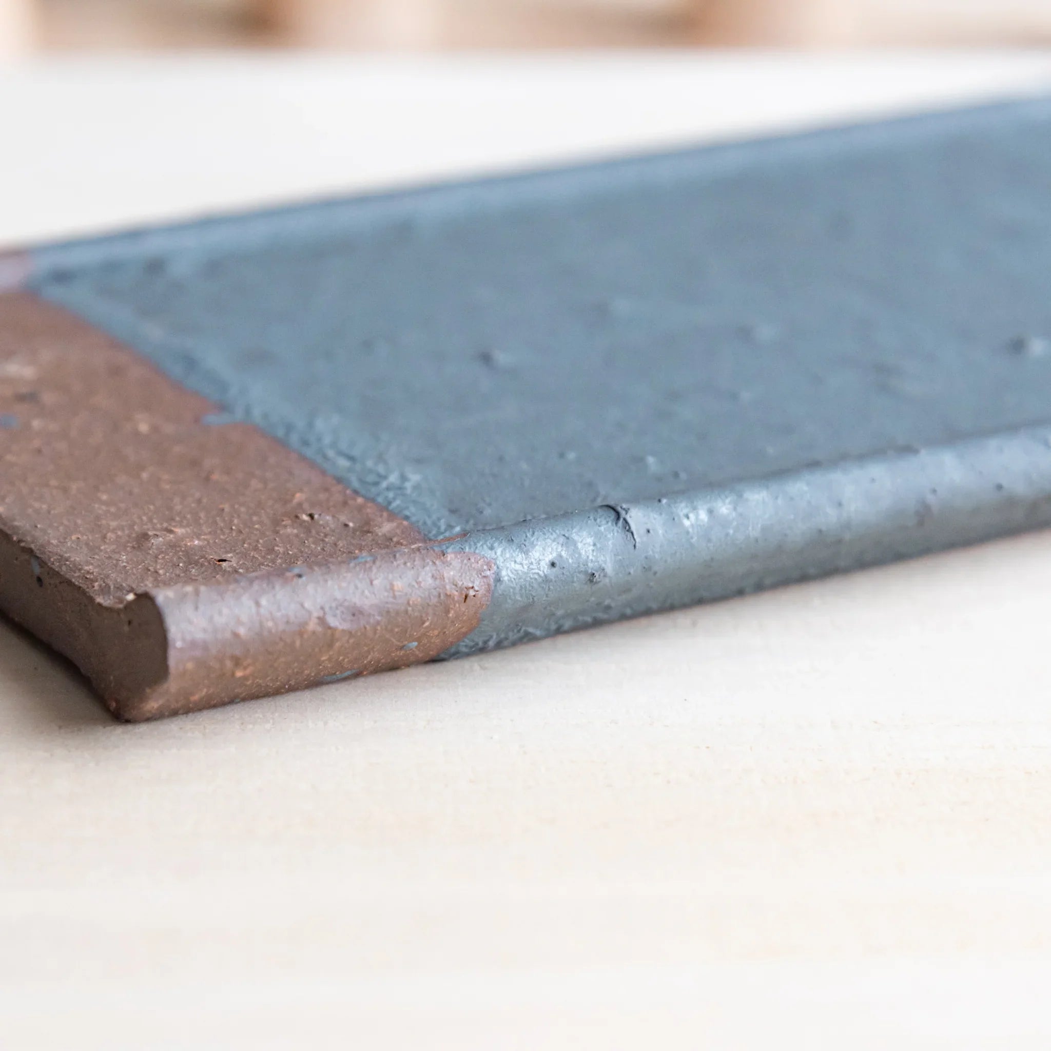 Echizen Kawara silver gray ceramic pen tray with four slots shown in composition displayed in detail