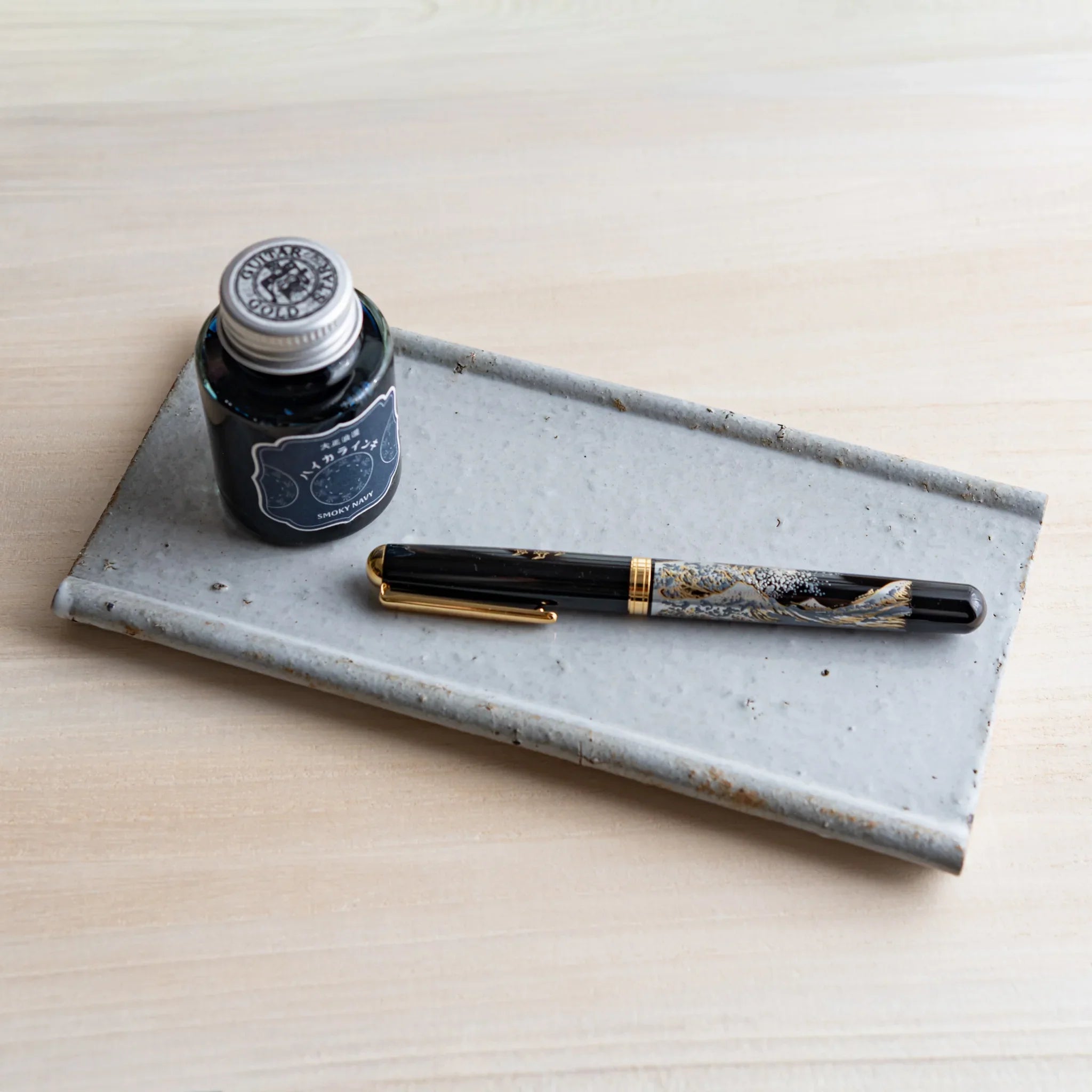 Angled view of Echizen Kawara white ceramic pen tray showing glaze texture and depth clearly displayed clearly