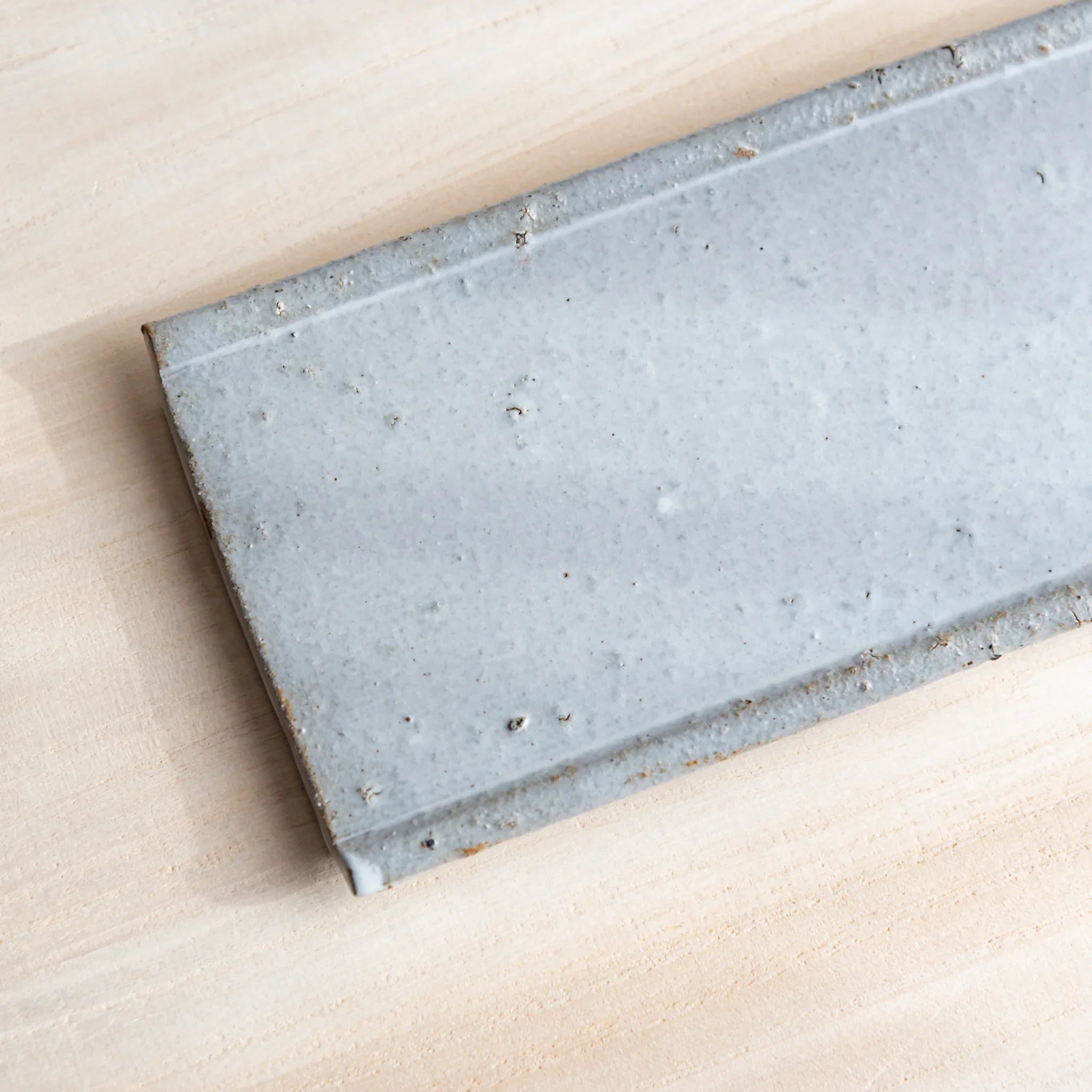 Echizen Kawara tray positioned at angle revealing depth and white glaze surface characteristics clearly visible