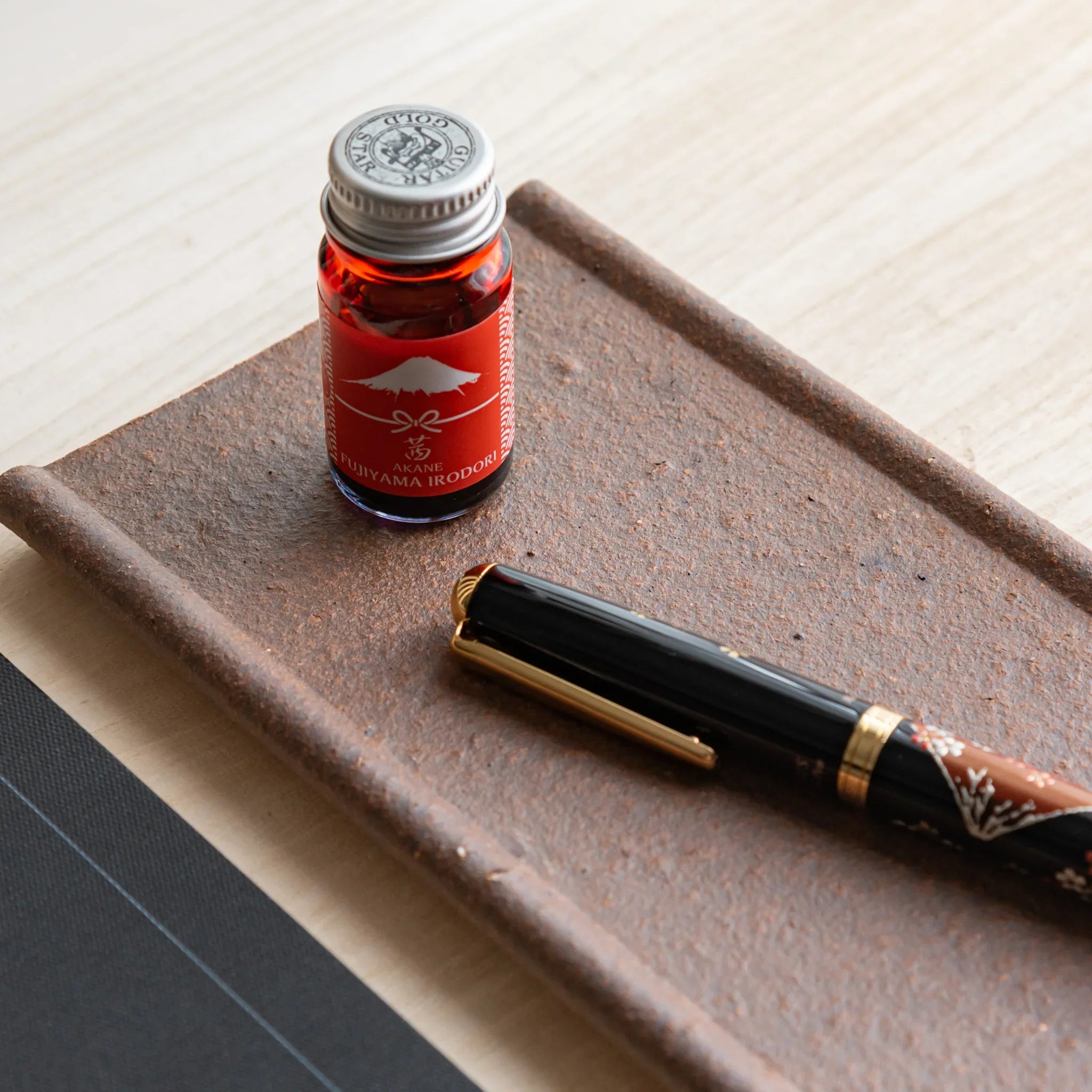 Japanese Pen Tray Desk Accessory, yakishime-clay ceramic tray with fountain pen and ink placed diagonally and notebook.