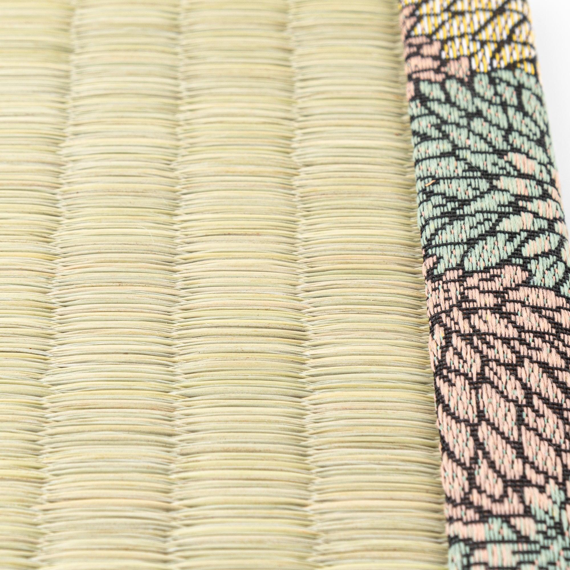 Detailed macro shot of Chrysanthemum Tatami Pen Tray surface showing woven rush texture beside floral brocade trim