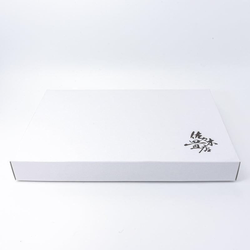White box with black kanji branding, designed for packaging traditional Japanese stationery, reflecting simplicity and elegance in its presentation.
