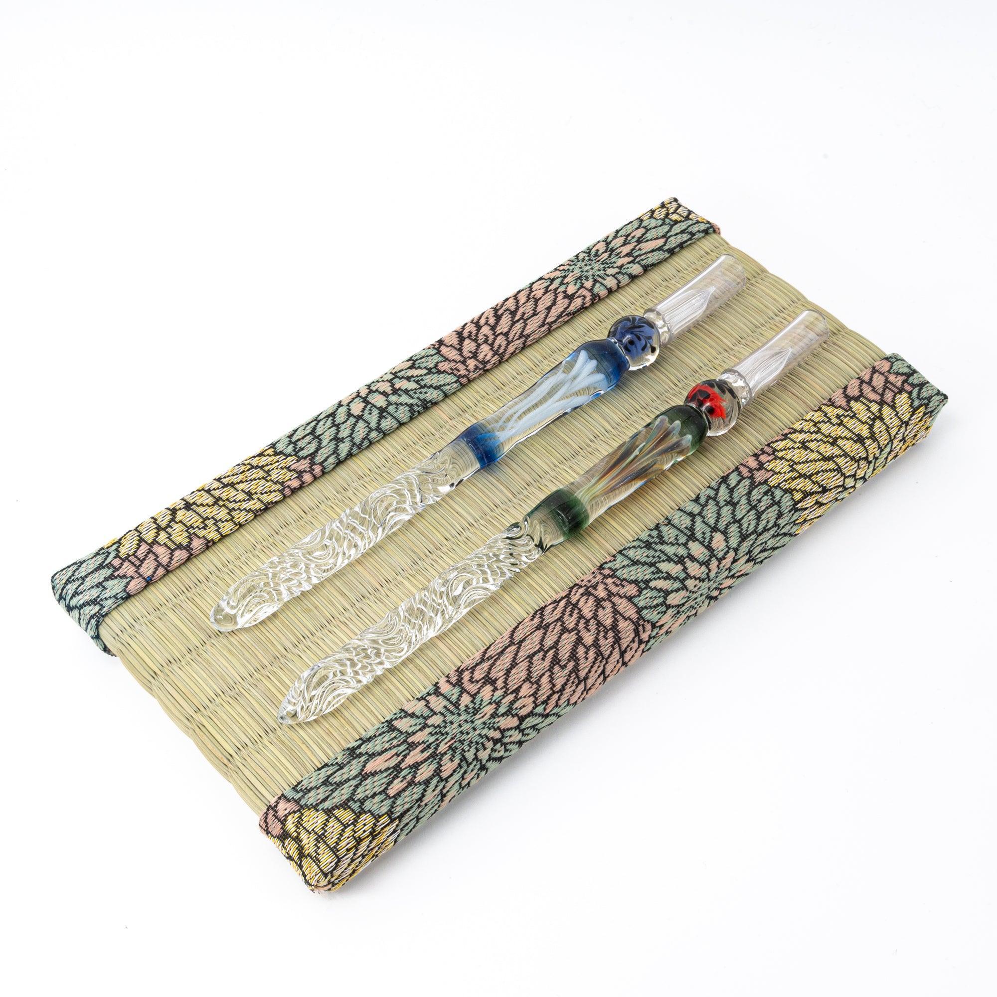 Chrysanthemum Tatami Pen Tray with three glass dip pens in blue, clear, and red-green bead styles on white background