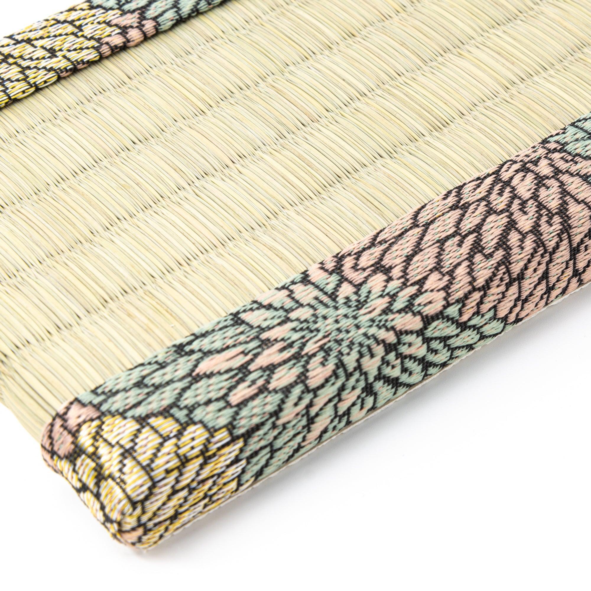 Close-up of the floral-patterned fabric on a tatami pen tray, highlighting the intricate craftsmanship used in Japanese stationery displays.