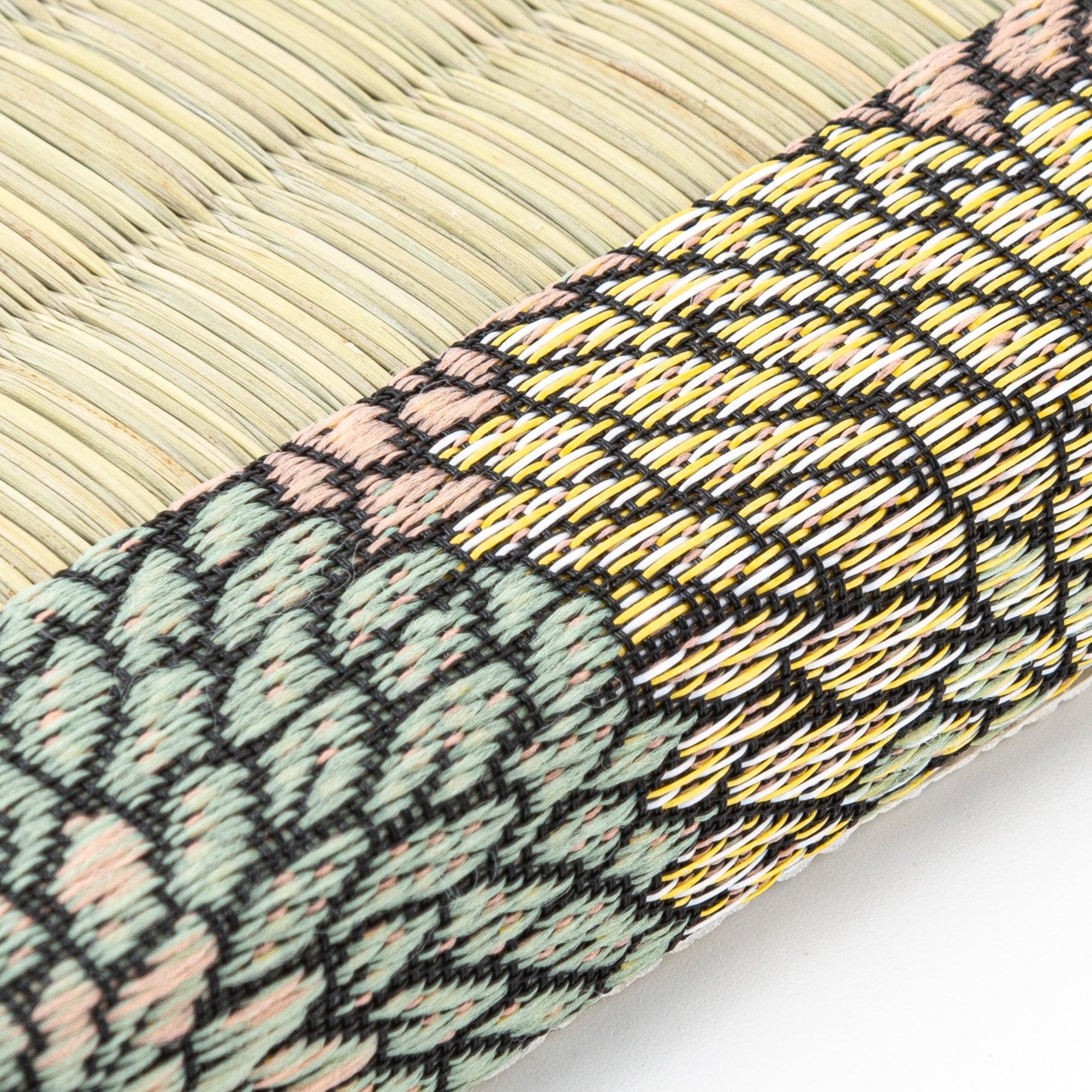 Close-up of the intricate floral-patterned fabric border on a tatami pen tray, showcasing the fine craftsmanship of Japanese stationery design.