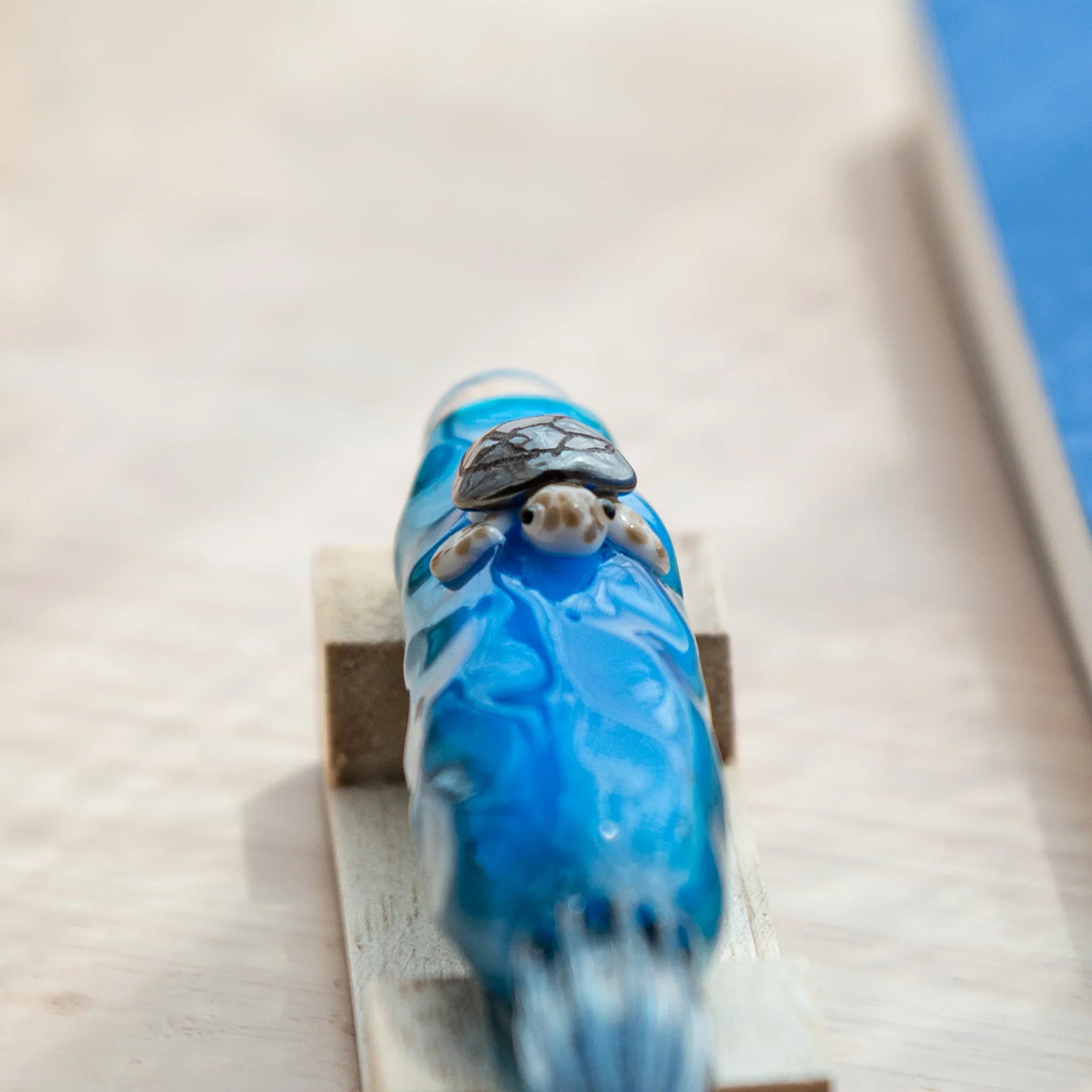 Sea turtle glass dip pen with floating figure inside clear barrel showing detail, hand-made Japanese pen