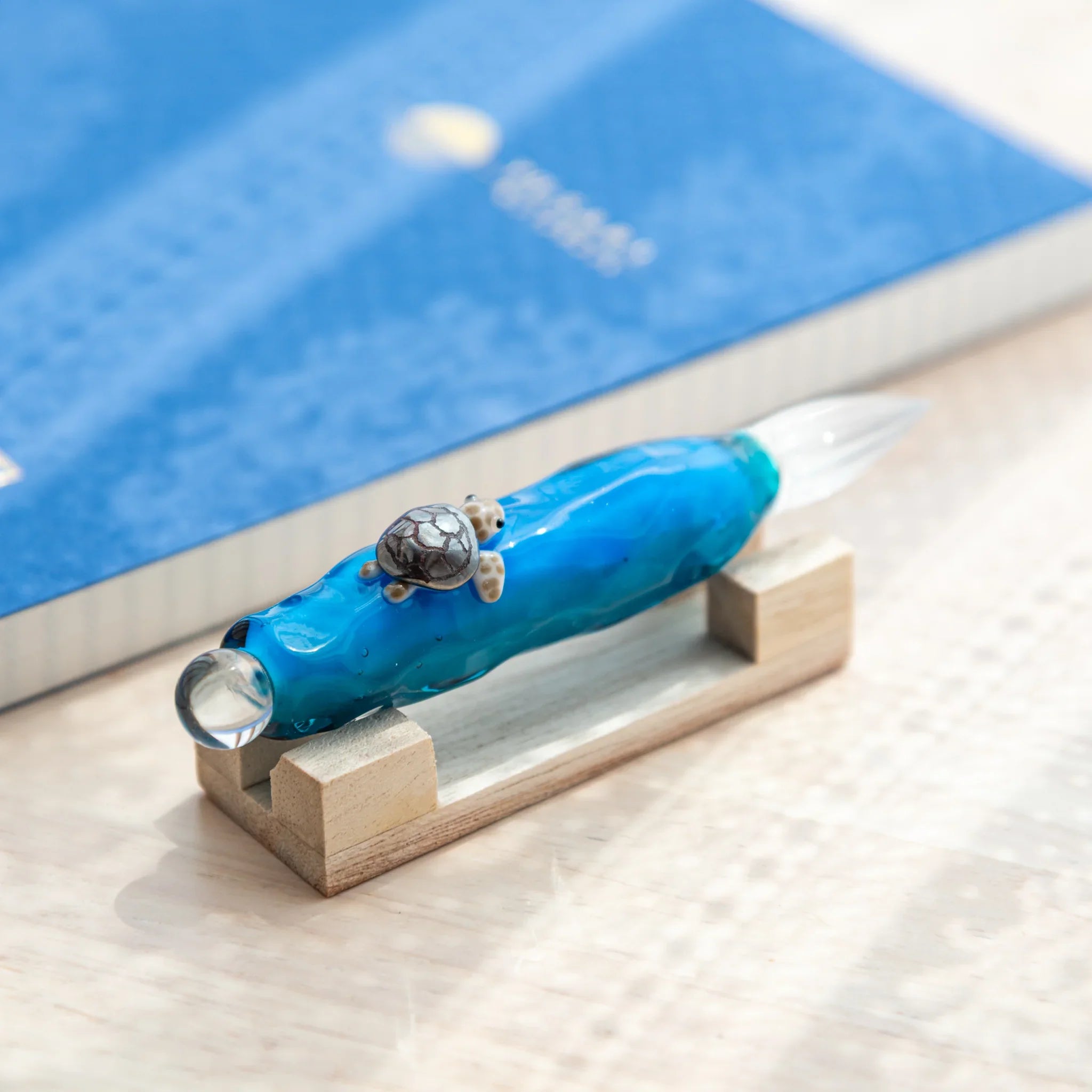 Floating Sea Turtle Japanese Glass Dip Pen with crystal-clear glass nib and blue wave body accented by a turtle.
