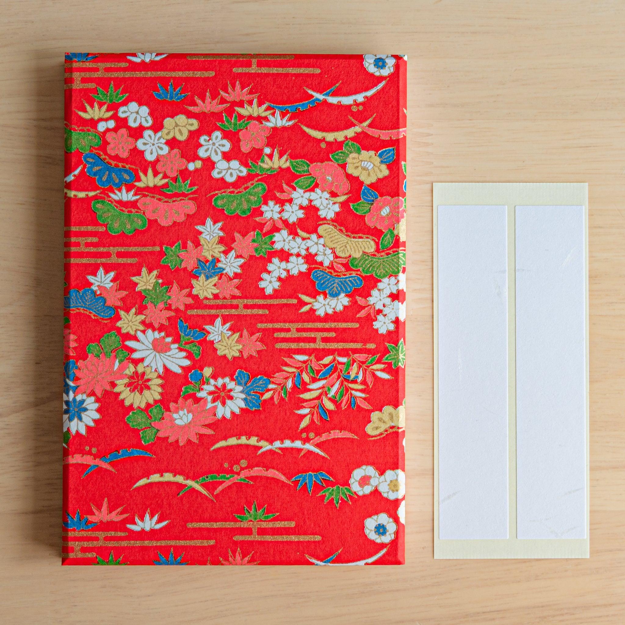 Goshuinsho stamp book in goen packaging, featuring bold red and floral design, a standout piece of Japanese stationery.