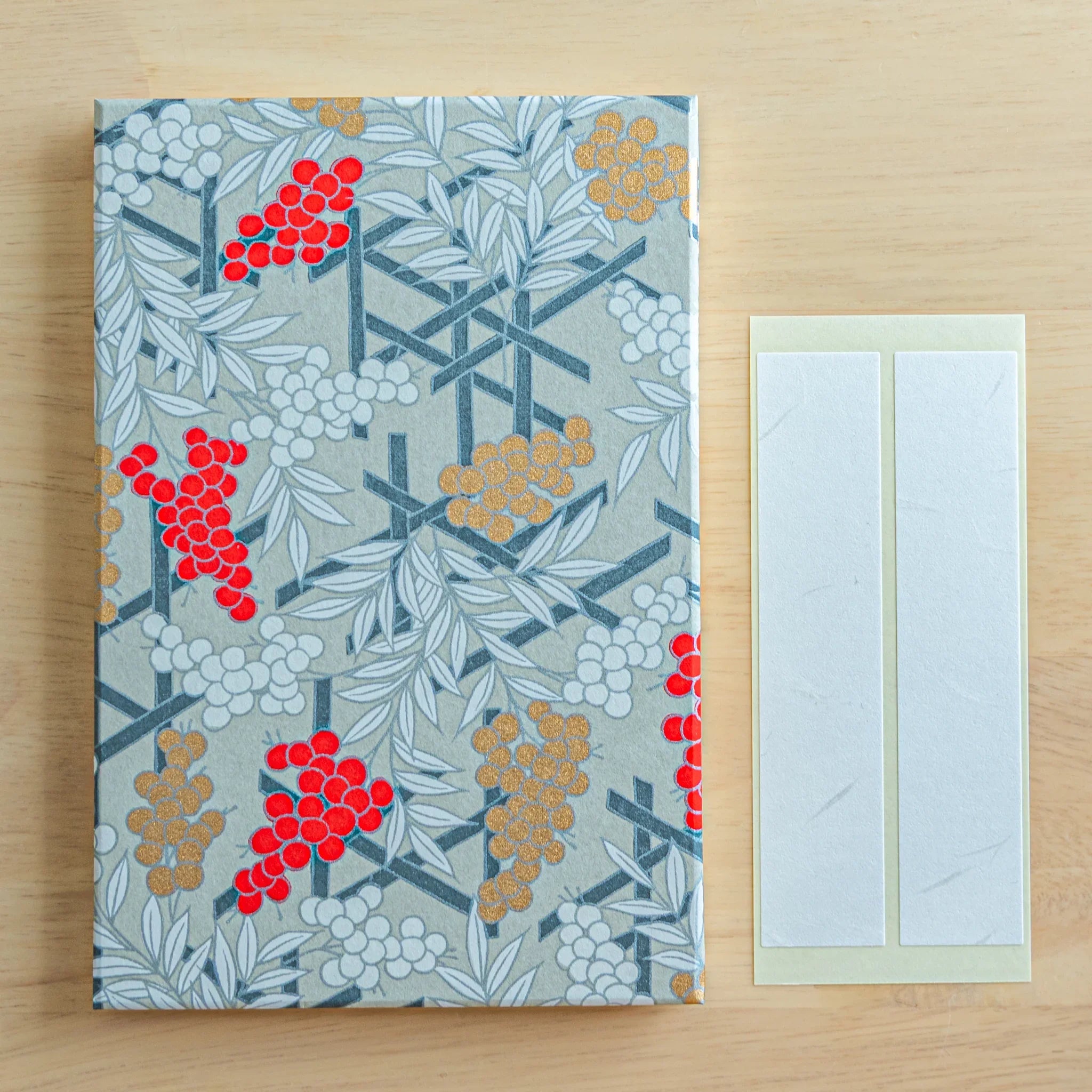 Nandina washi Japanese goshuincho stamp book in gray with red and gold berry lattice, two white washi bookmark strips