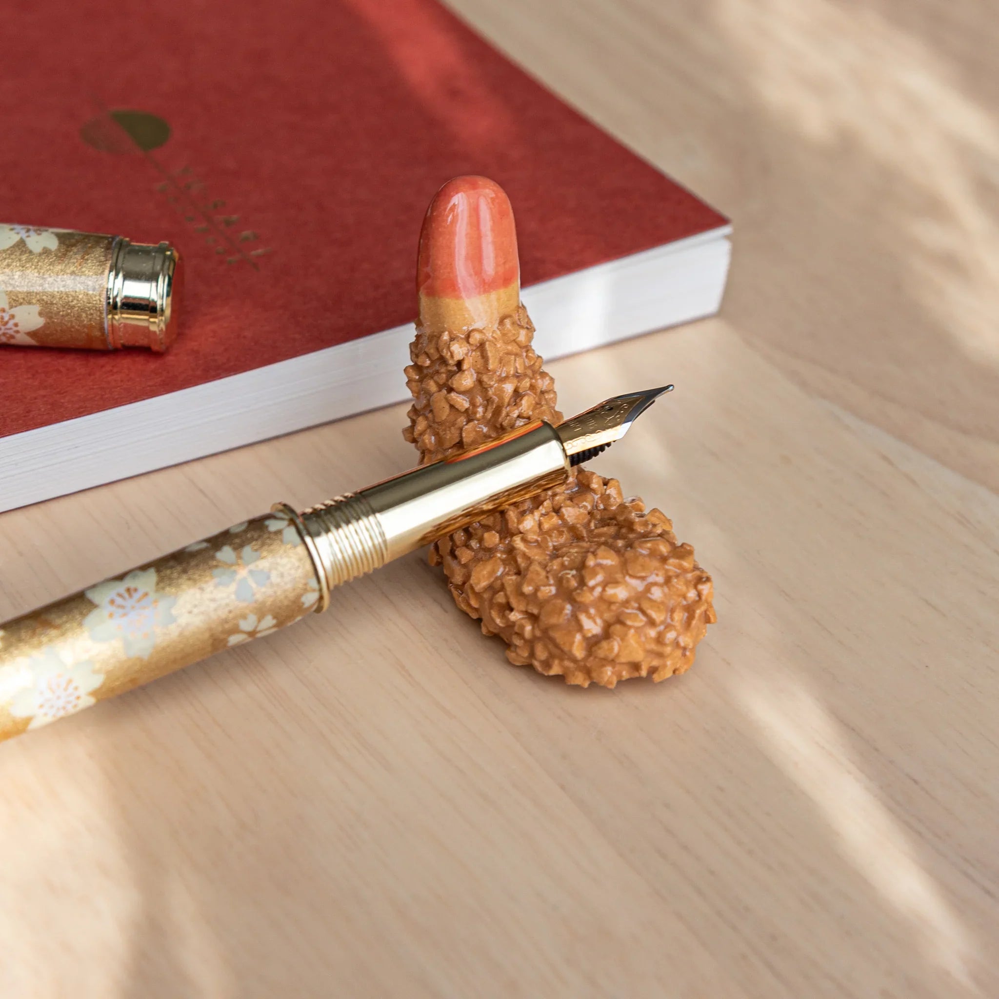 Bright orange fried shrimp Japanese handcrafted pen rest with detailed realistic surface texture showing food authenticity