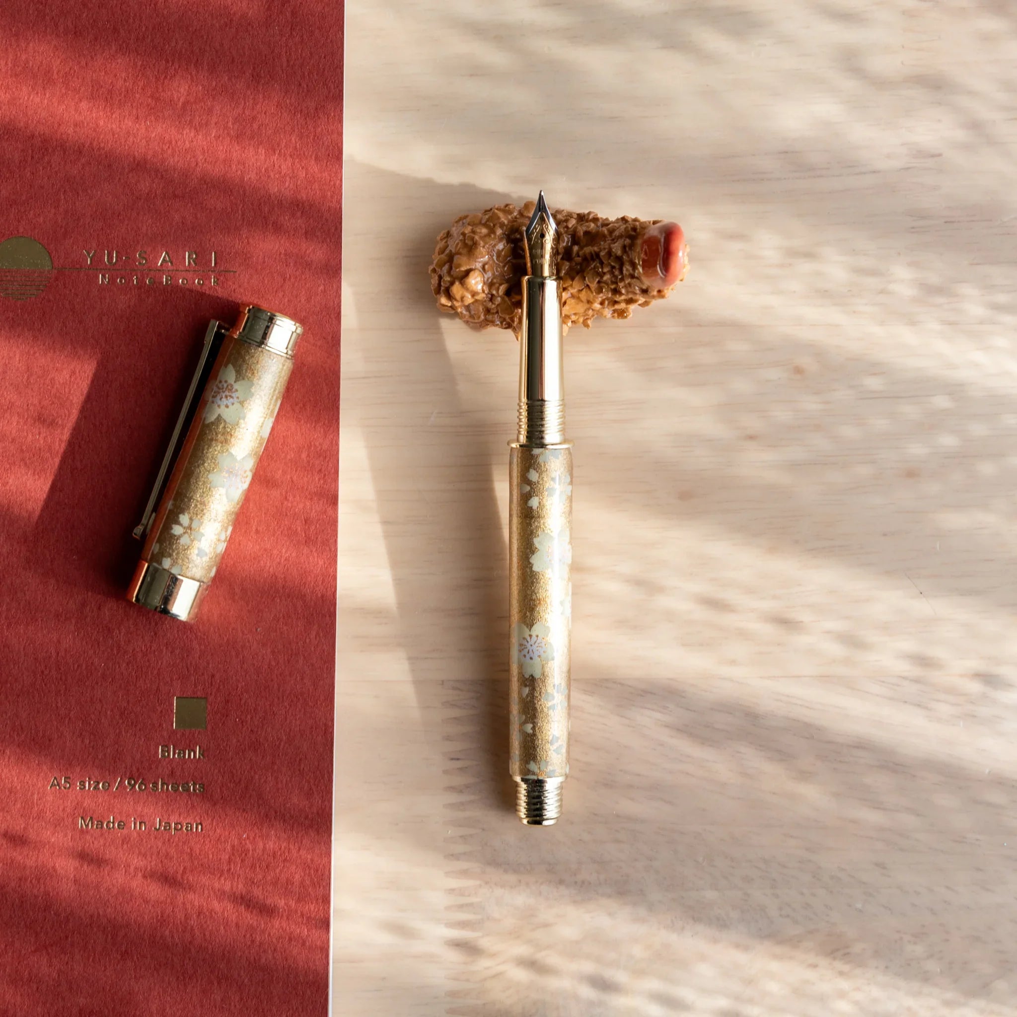 Curved orange shrimp tempura shaped handcrafted pen rest with authentic Japanese food styling and detailed crumb texture