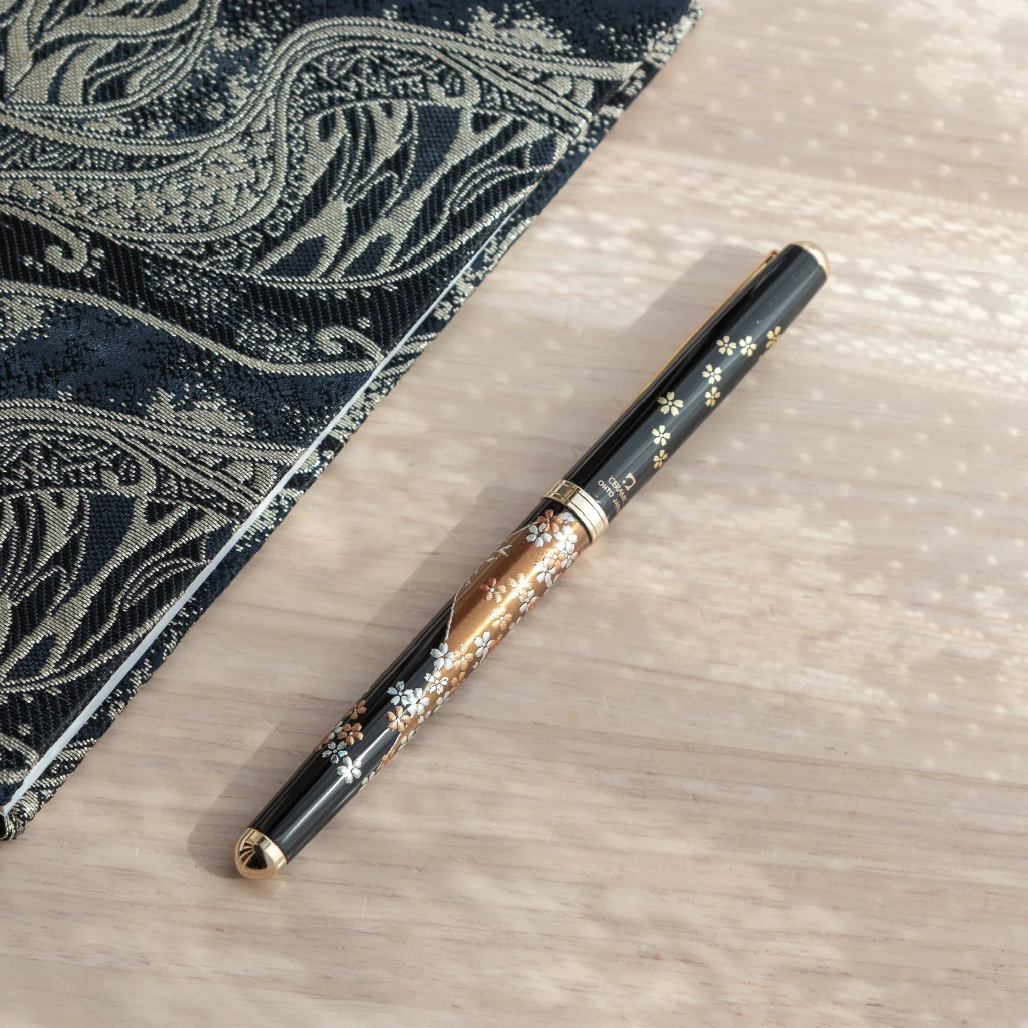 Japanese Ballpoint Pen with Lacquer sakura blossoms and Mt. Fuji details, golden trim, and ceramic branding.