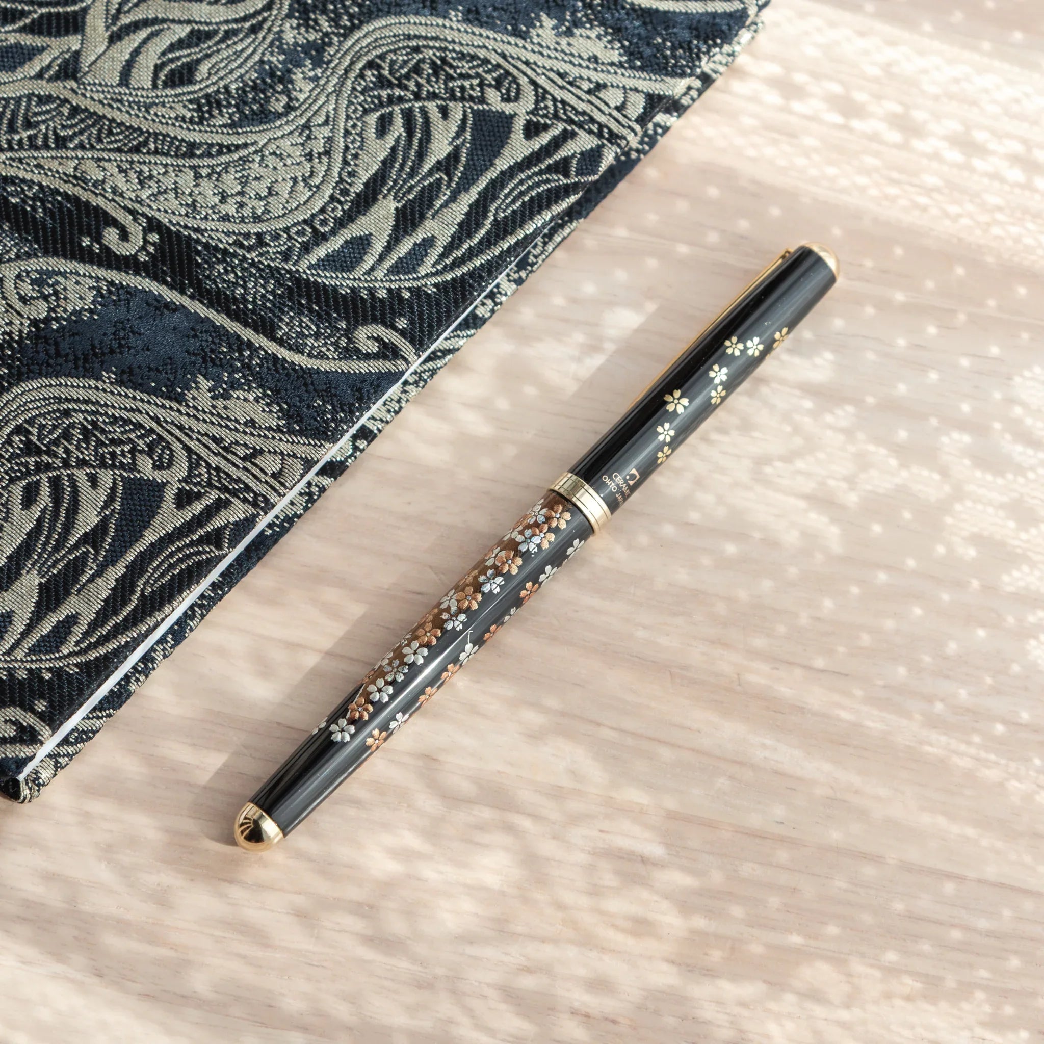 Japanese Ballpoint Pen with Lacquer sakura blossoms and Mt. Fuji details, golden trim, and ceramic branding.