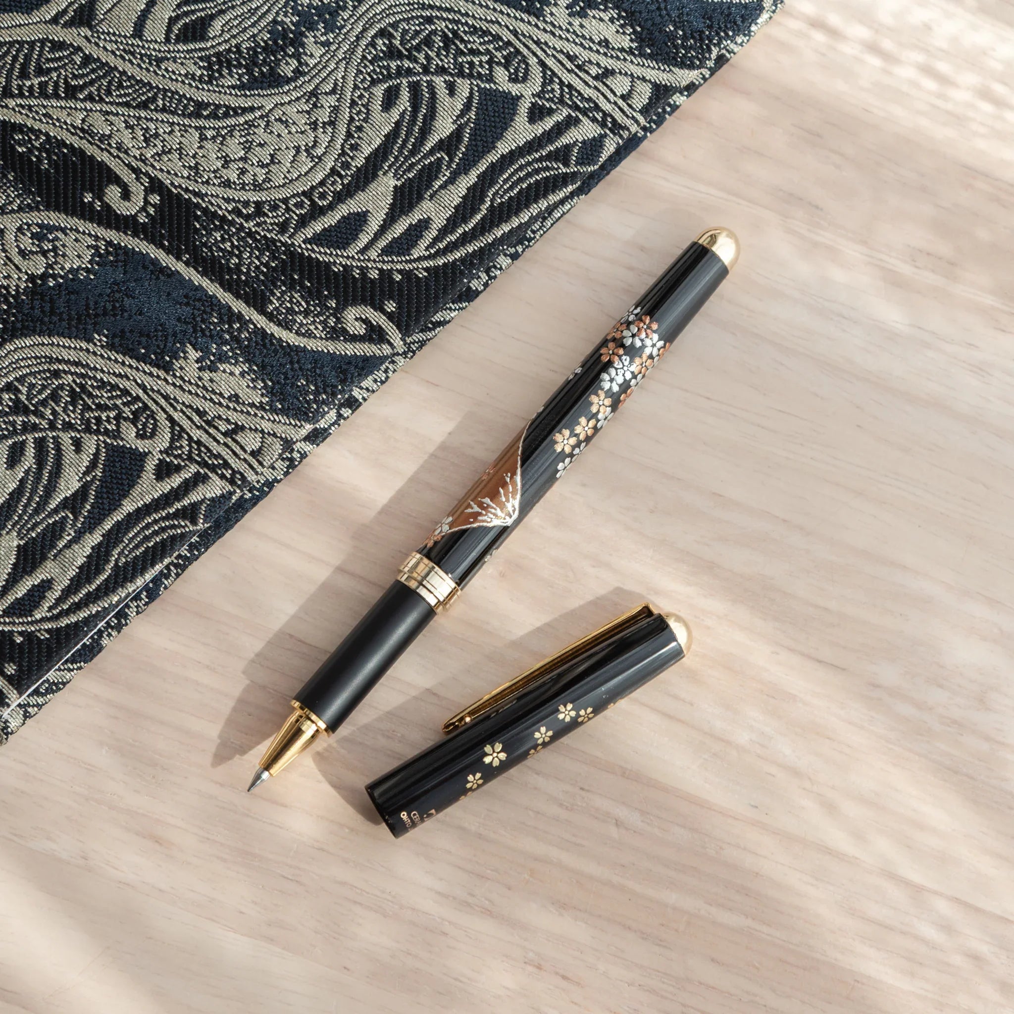 Capped-off Japanese Ballpoint Pen with Lacquer finish, featuring sakura and Mt.Fuji design on a black glossy body.