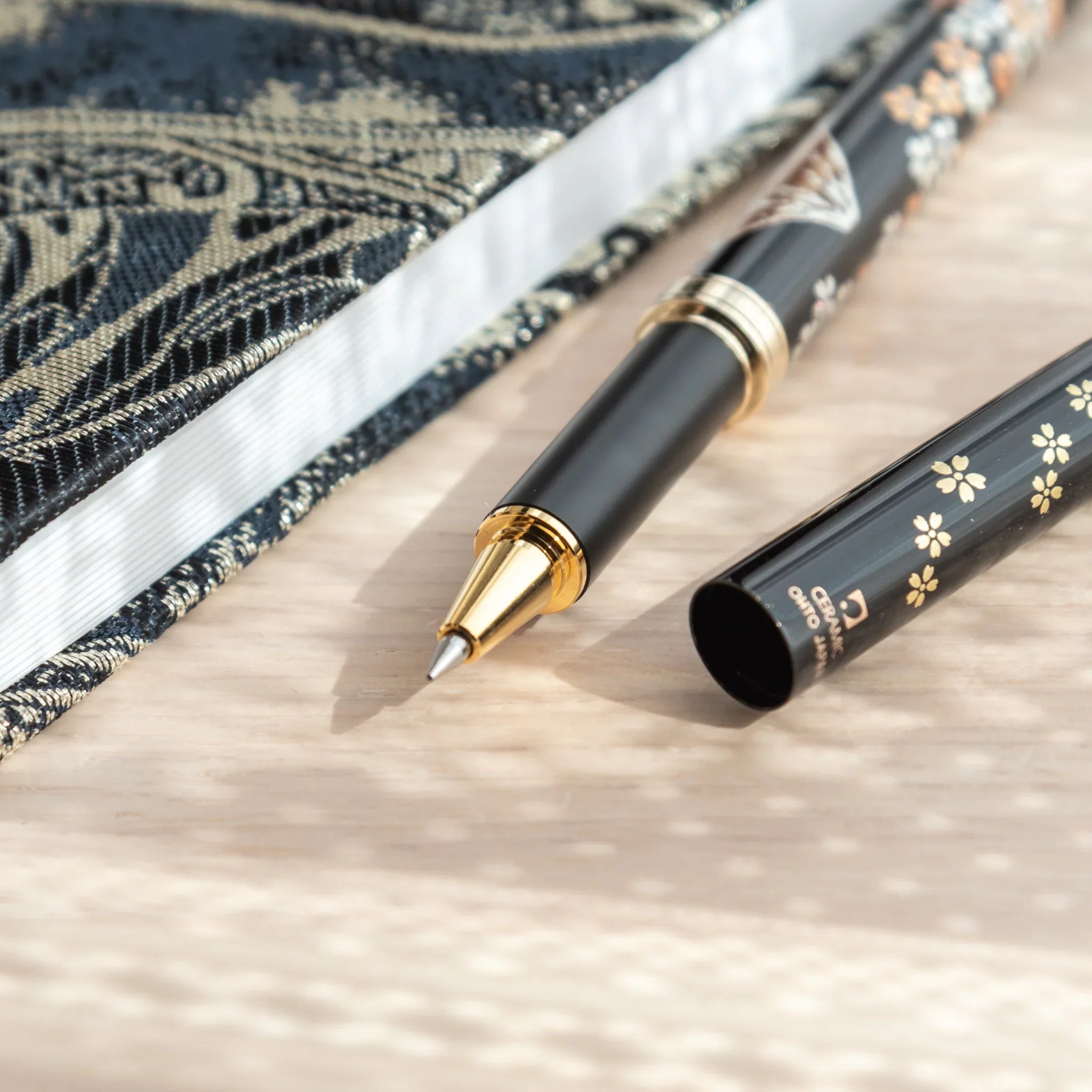 Hand-painted Yamanaka lacquer ballpoint pen depicts iconic Mount Fuji with pink sakura blossoms for writing