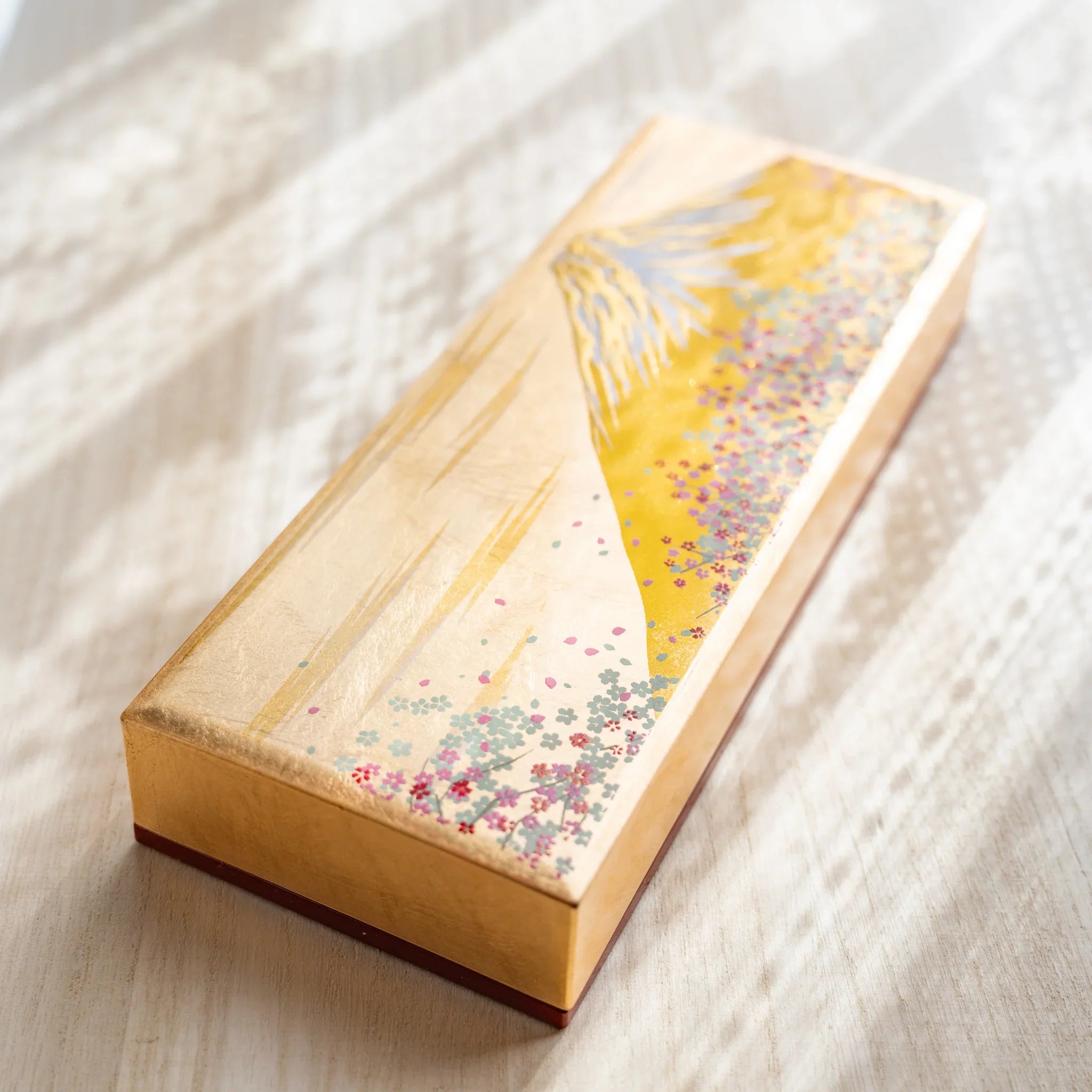 Fuji Sakura pen case in three-quarter view showing gold finish and complete designs displayed clearly